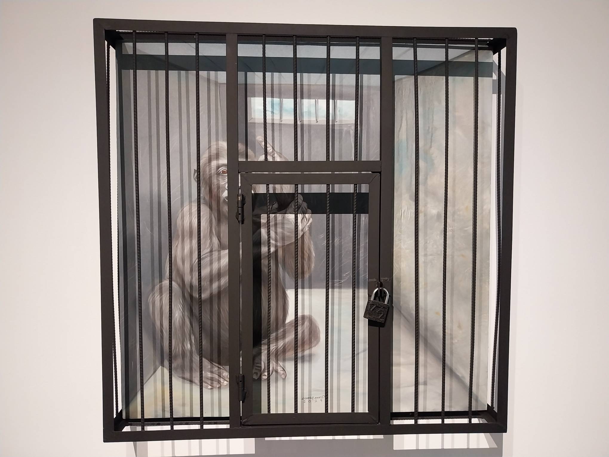 A painting of a monkey behind a cage. Photo by Elle Yap.