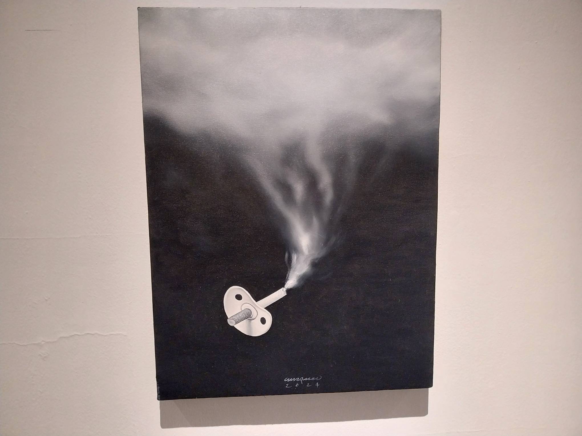 Work shown in "ANYAREH" depicting a pacifier with a cigarette. Photo by Elle Yap.