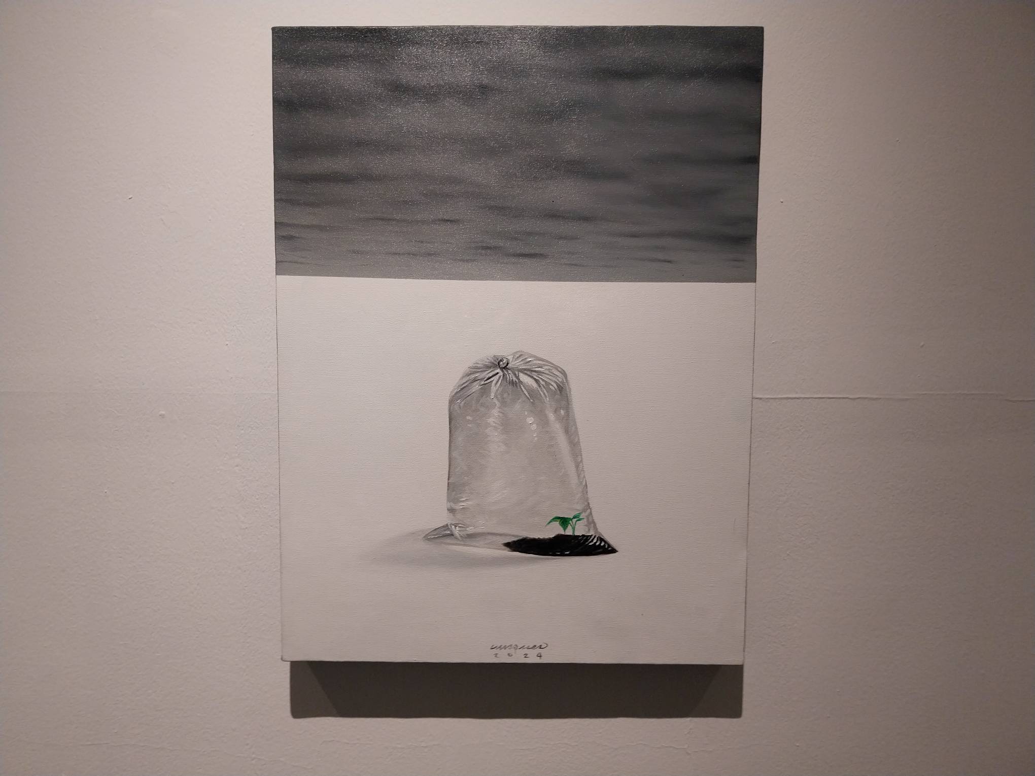 Work by depicting a plastic bag with land under the ocean. Photo by Elle Yap.