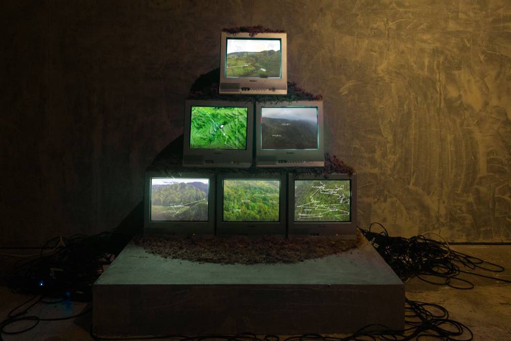 A stack of televisions showing the lush mountainside. Photo provided by Mono8 Gallery.