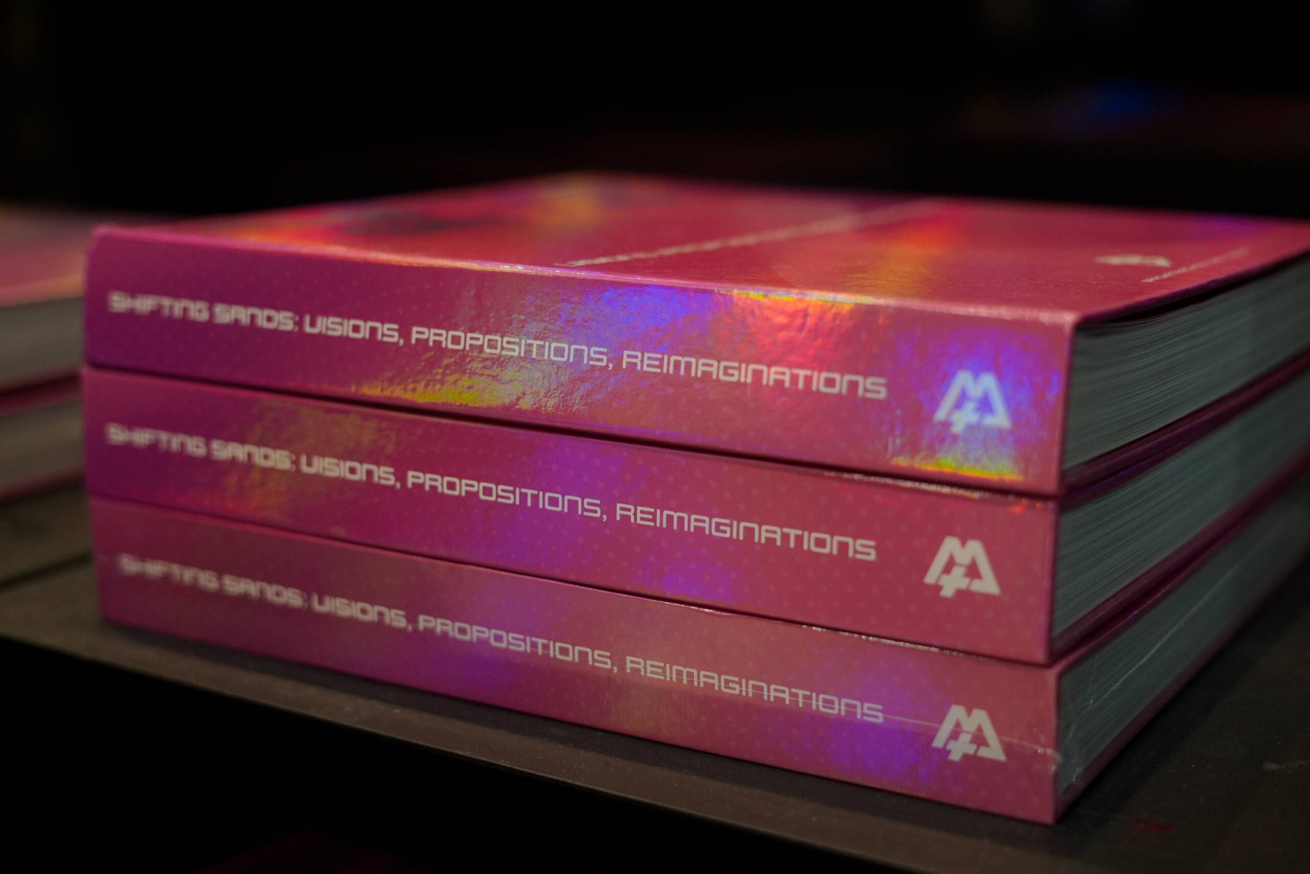 Copies of"Shifting Sands" at Spruce Gallery event. Photo by Omar Villanueva.
