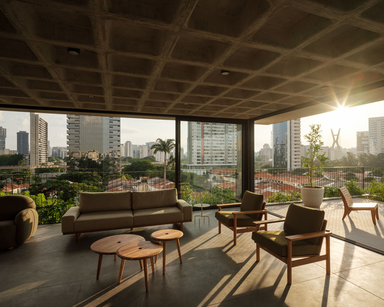 Living room area of one of the apartments during golden hour. Photo by Pedro Kok and Rafael Fiorotto.