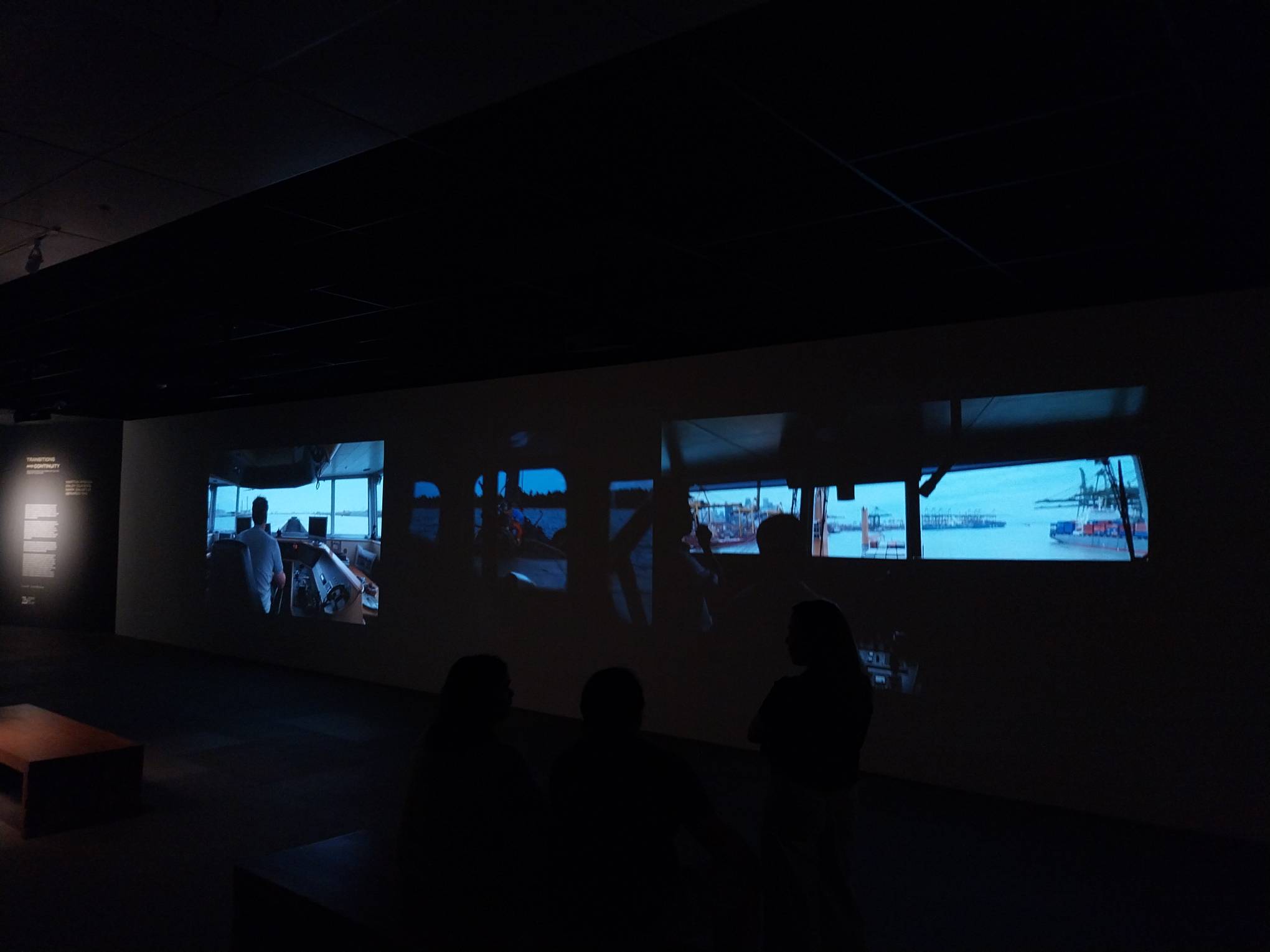 People watching Martha Atienza's work for "Transitions and Continuity," a video art exhibit from Ateneo Art Gallery. Photo by Patricia Yap.