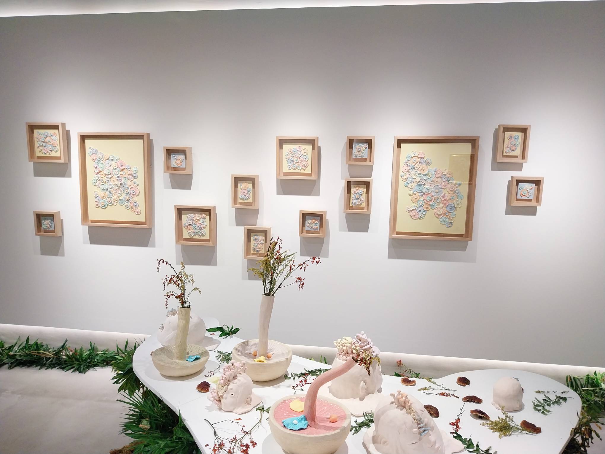 The table and wall of the Galerie Stephanie exhibit. Photo by Elle Yap