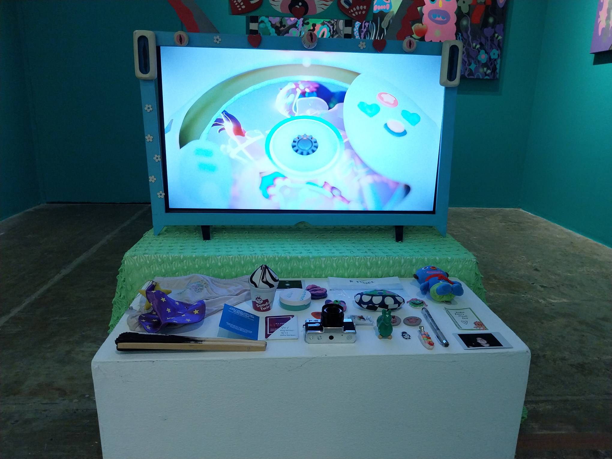 A television with trinkets in a table. Photo by Elle Yap.