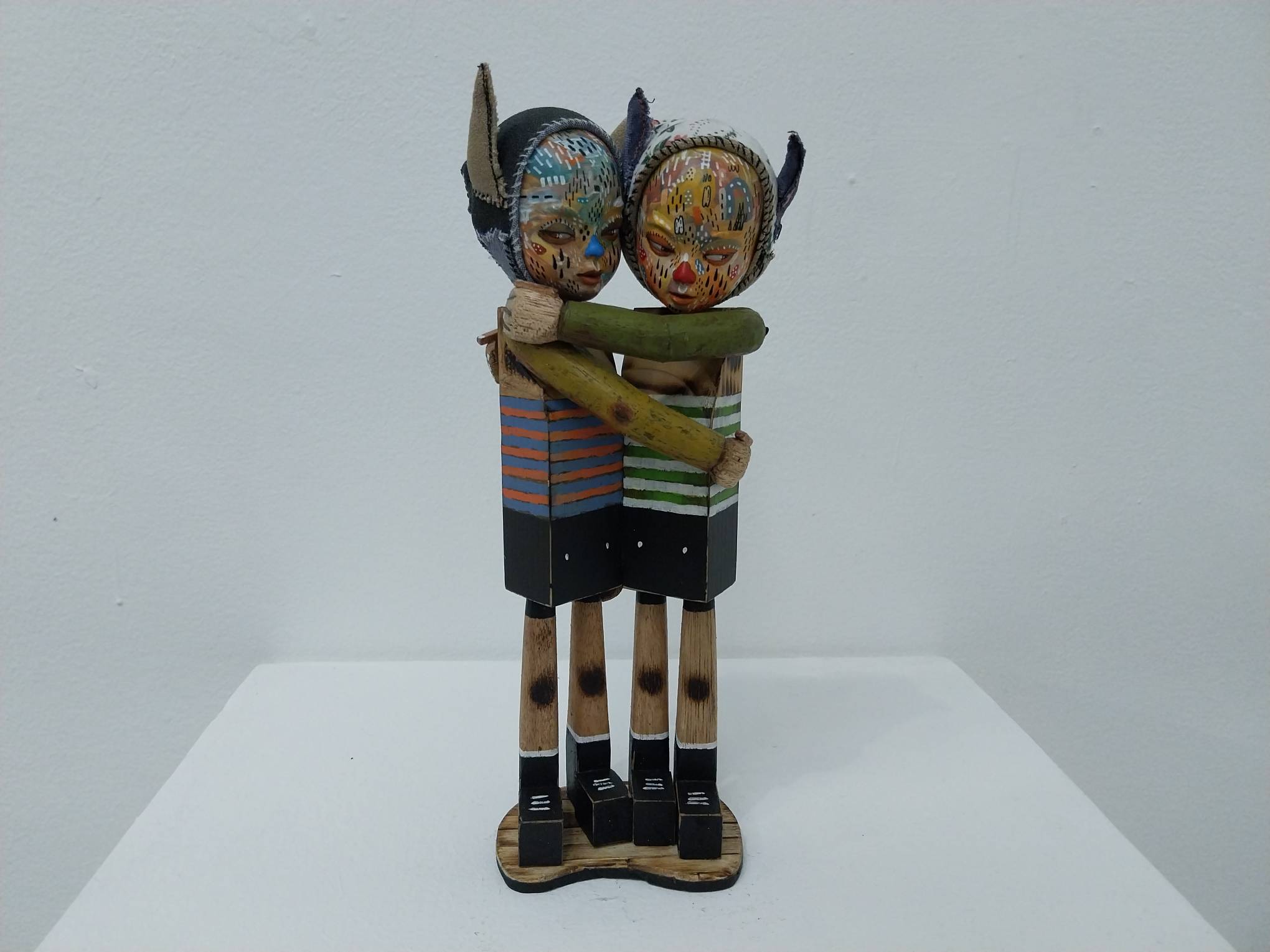 Two figures hugging each other as shown in "Muscle Land." Photo by Elle Yap.