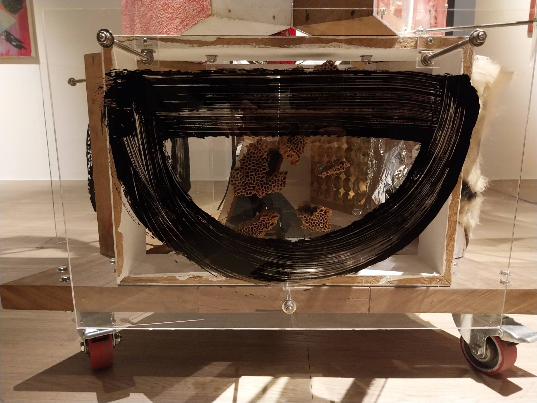 Markings in front of a box in "Lodi" at the exhibit "SACRUS:MUNDUS." Photo by Elle Yap.