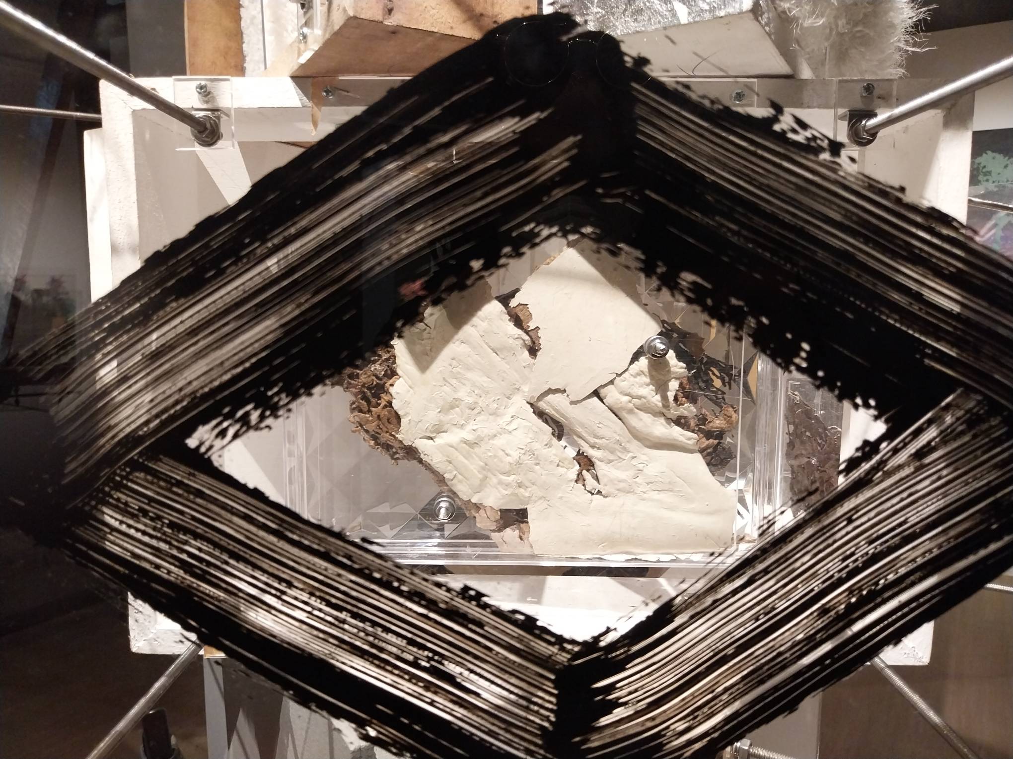 Markings in front of a box in "Lodi" at the exhibit "SACRUS:MUNDUS."