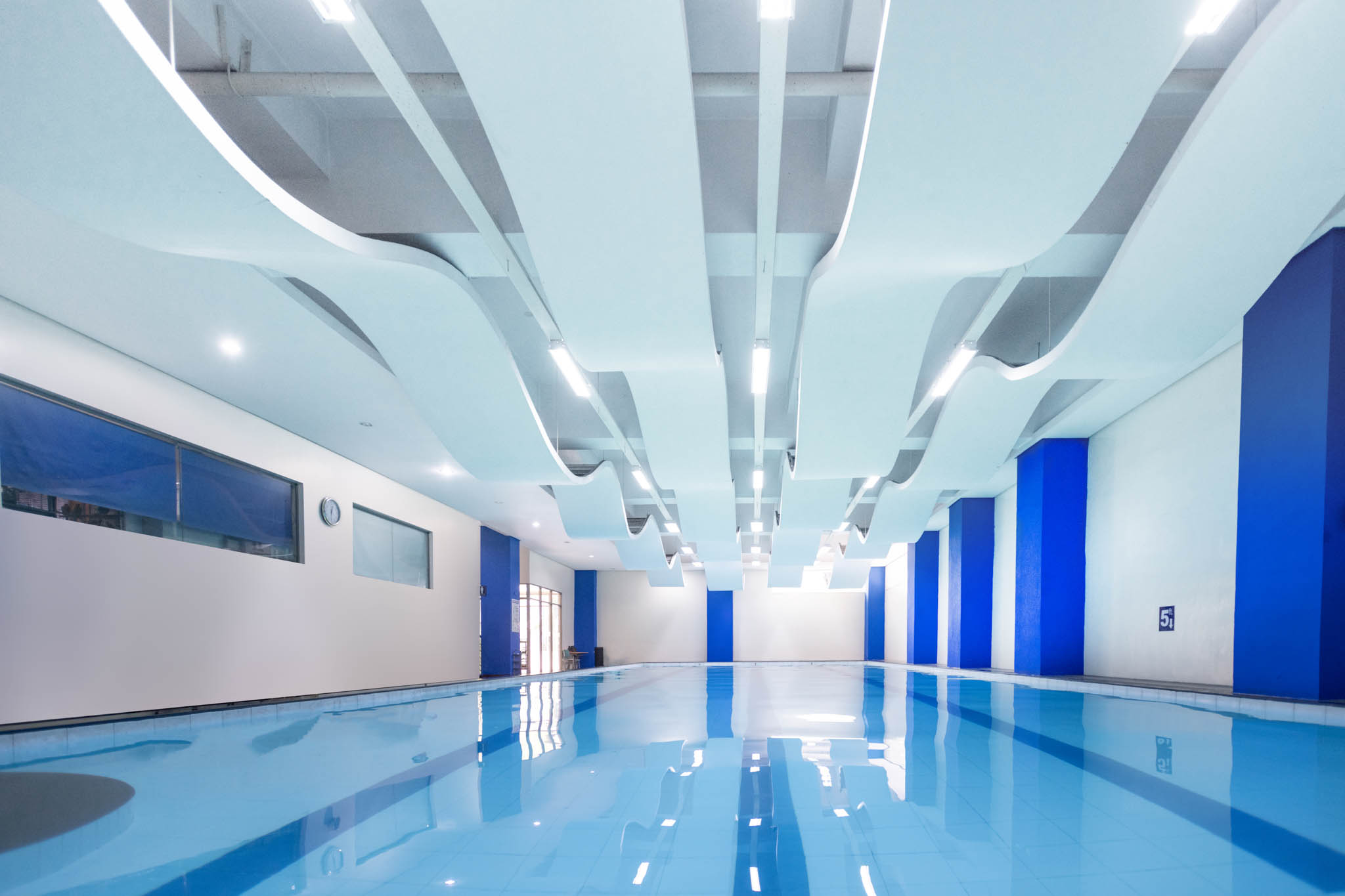 The pool area with wave-like ceiling