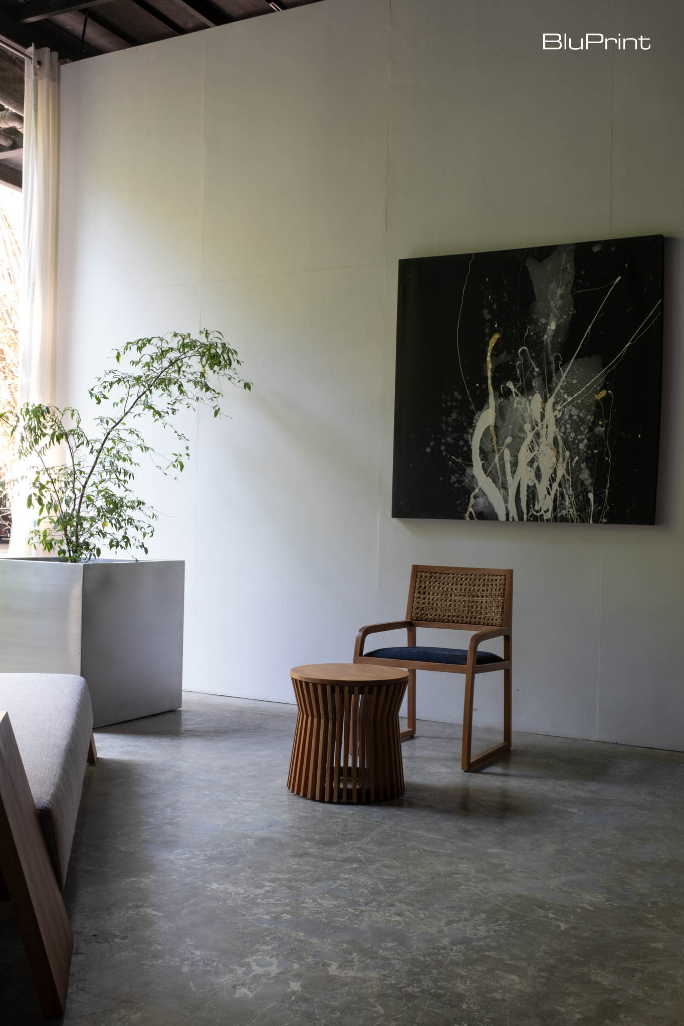 A wooden chair and side table where traditional materials meet modern forms are seen throughout OMO Furniture's collections.