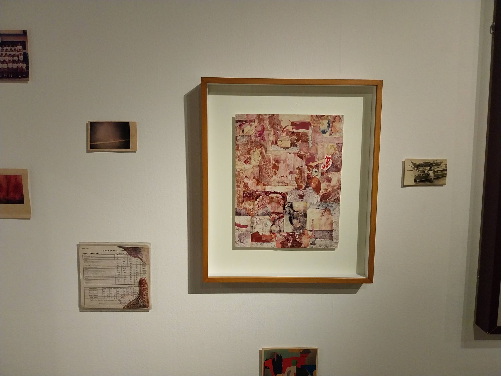 "Memories of Murmur" surrounded by a report card and old photographs. Photo by Elle Yap.