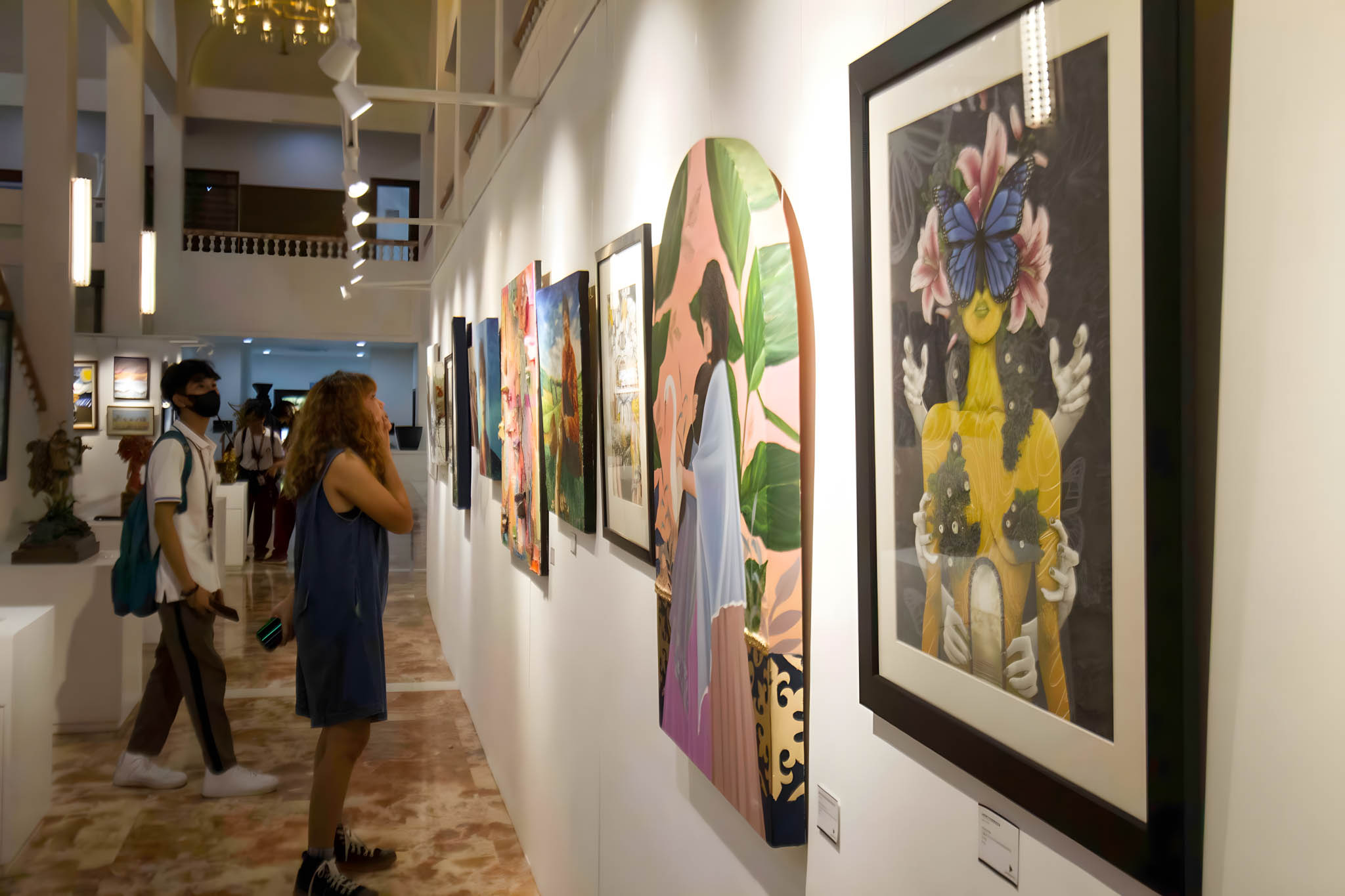 A visitor inspecting the art shown at the 2023 Luzon Art Fair. Photo provided by the organizers.