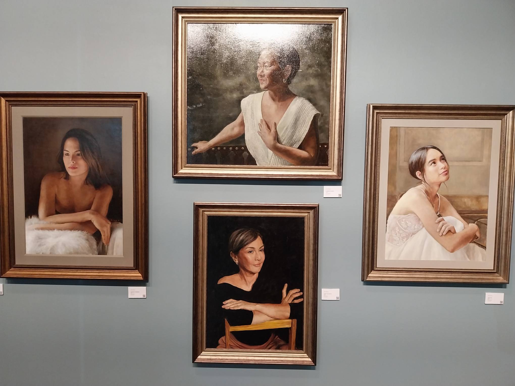 Four portraits by Mia Herbosa.