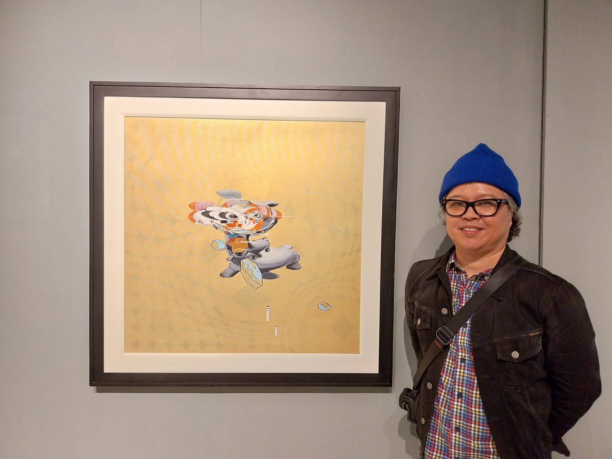 Clarence Chun and one of his works on display at Mono8 Gallery.