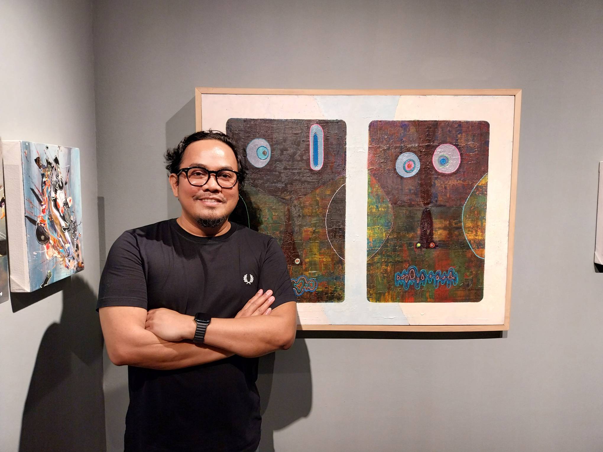 Luis Lorenzana and one of his works on display at Mono8 Gallery.