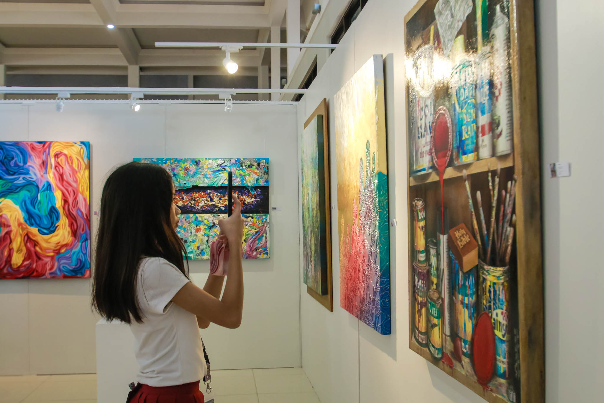 A person taking a picture of an artwork.