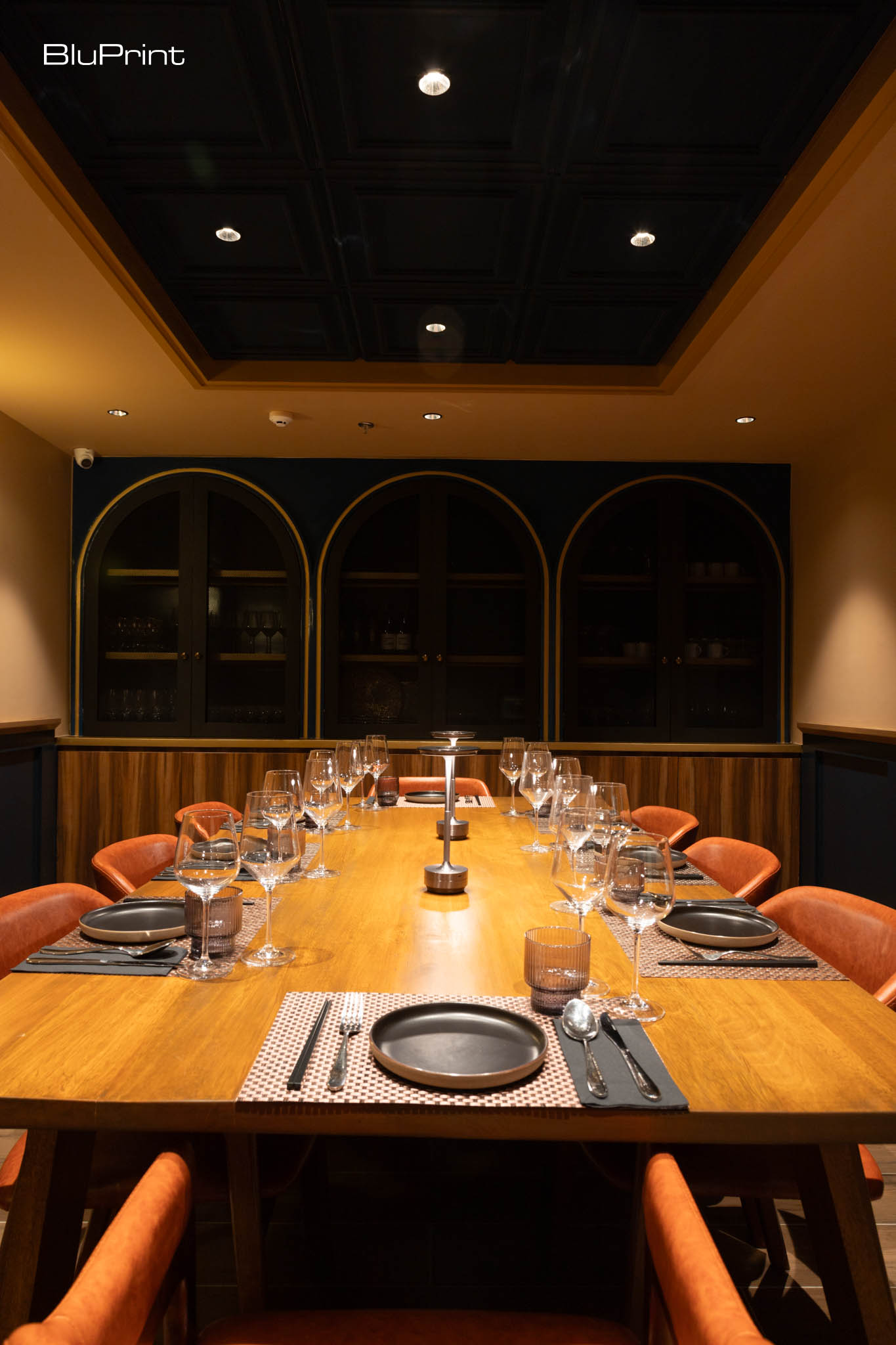 Oak & Smoke: A Culinary Fusion of Fire and Flavor. Warm lighting and sleek furnishings make the interior an inviting space, blending modern design with comfort.