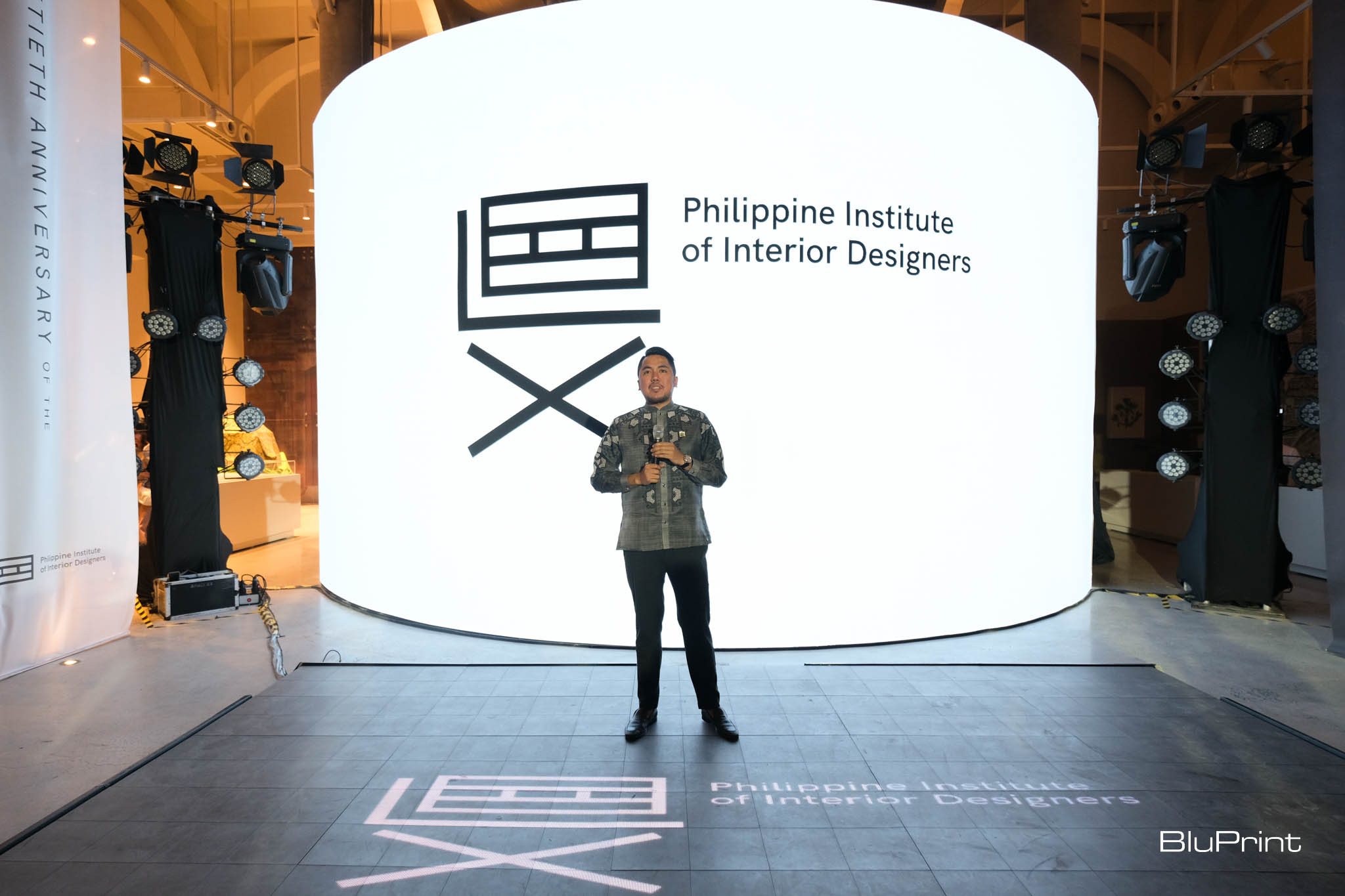 PIID National President Paolo Castro on stage giving a speech.