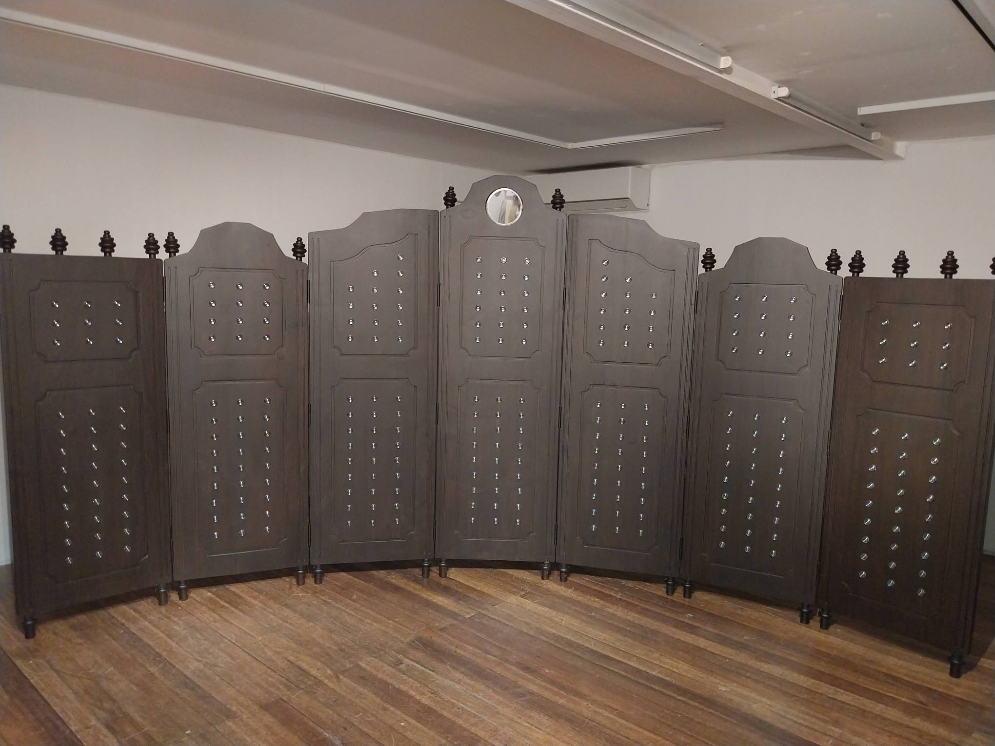 The imposing wooden divider in Audrey Lukban's "Behind the Scenes."
