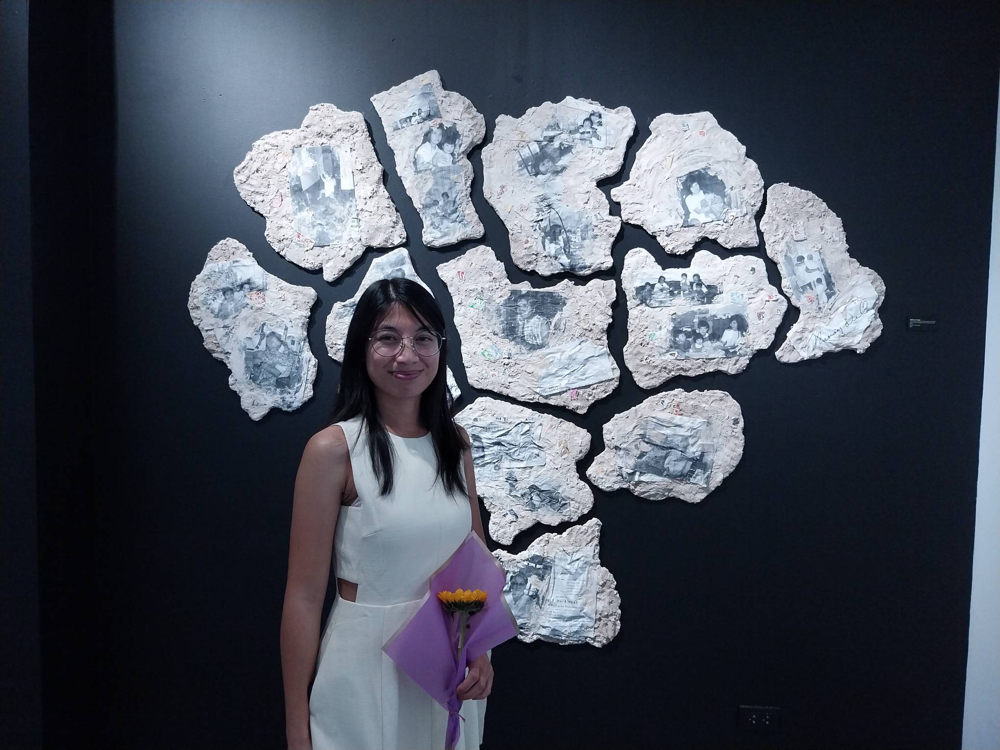 The artist Nicolei Buendia Gupit in front of one of her works for "Mother/land."