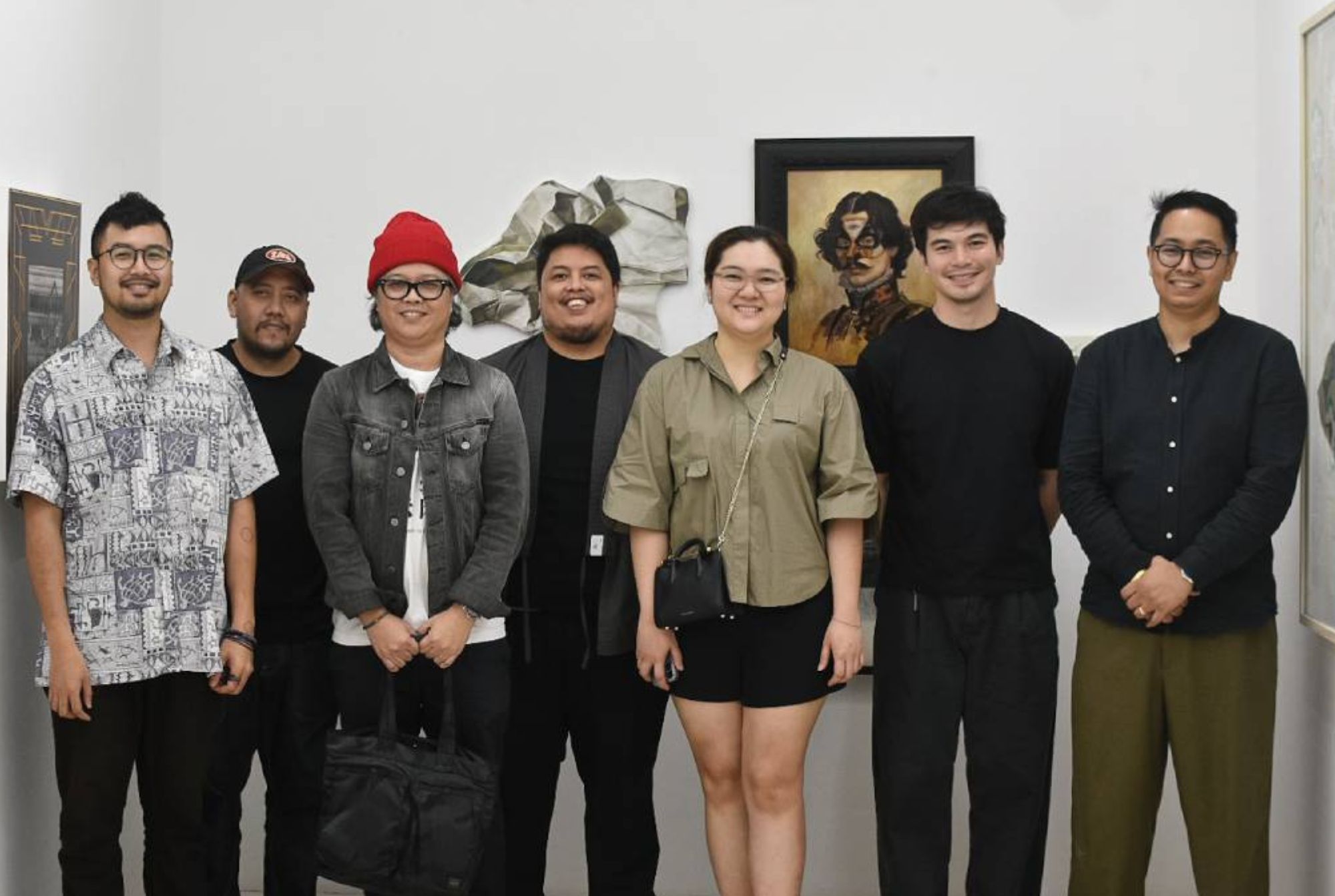 Some of the artists, as well as the curator, of 