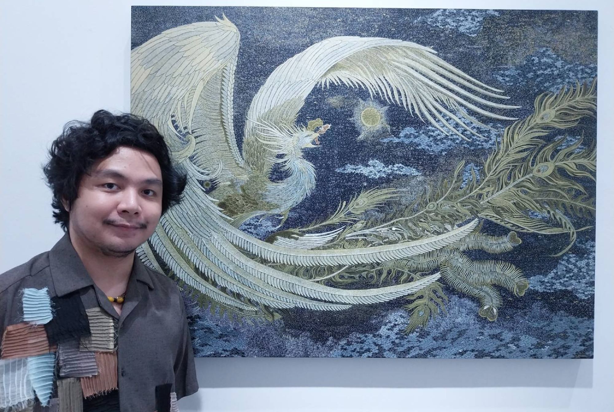 Joshua Barrera in front of one of his works for 