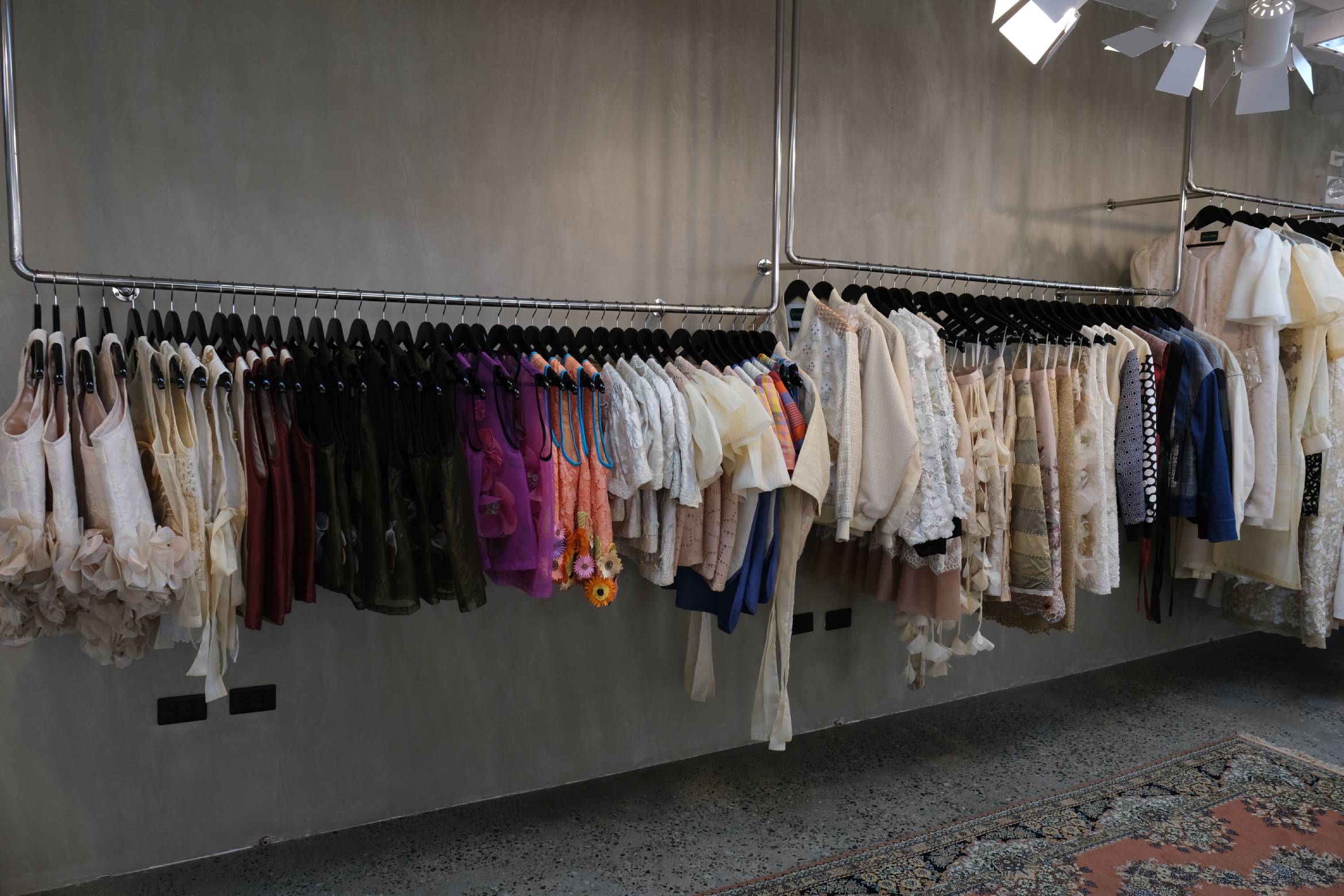Racks of clothes by Jor-El Espina.