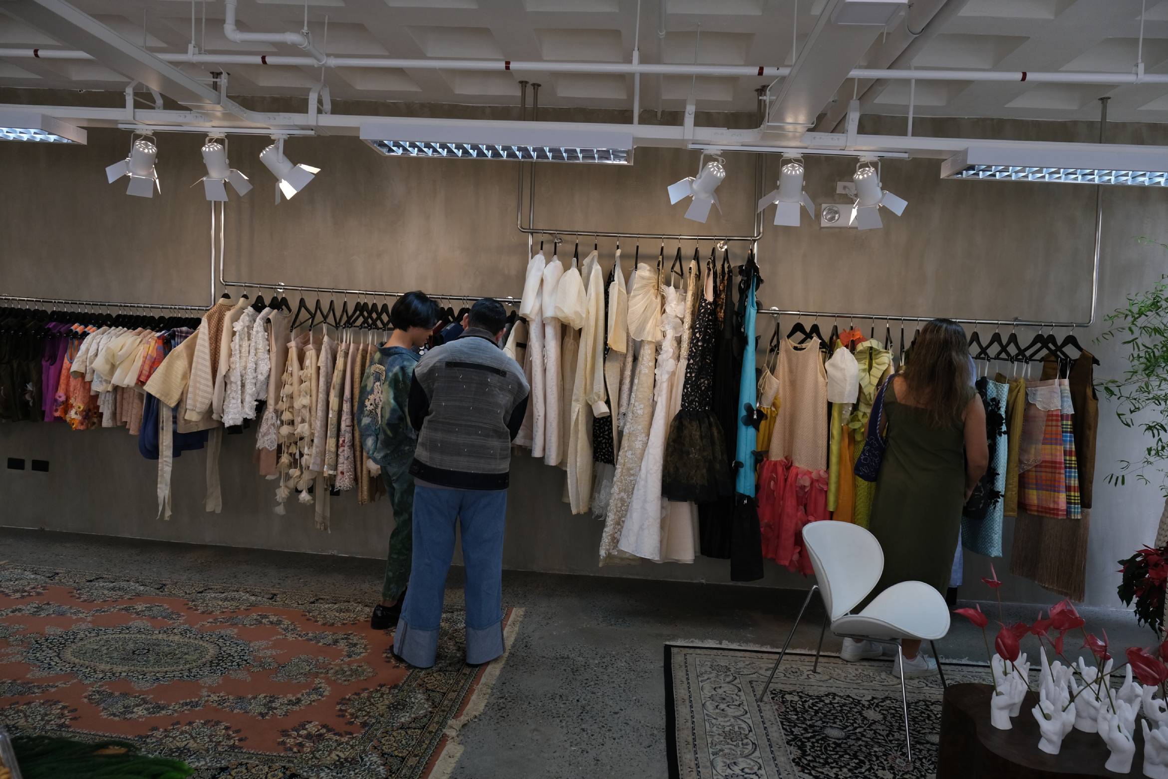 Clients looking through the clothing line at the atelier.