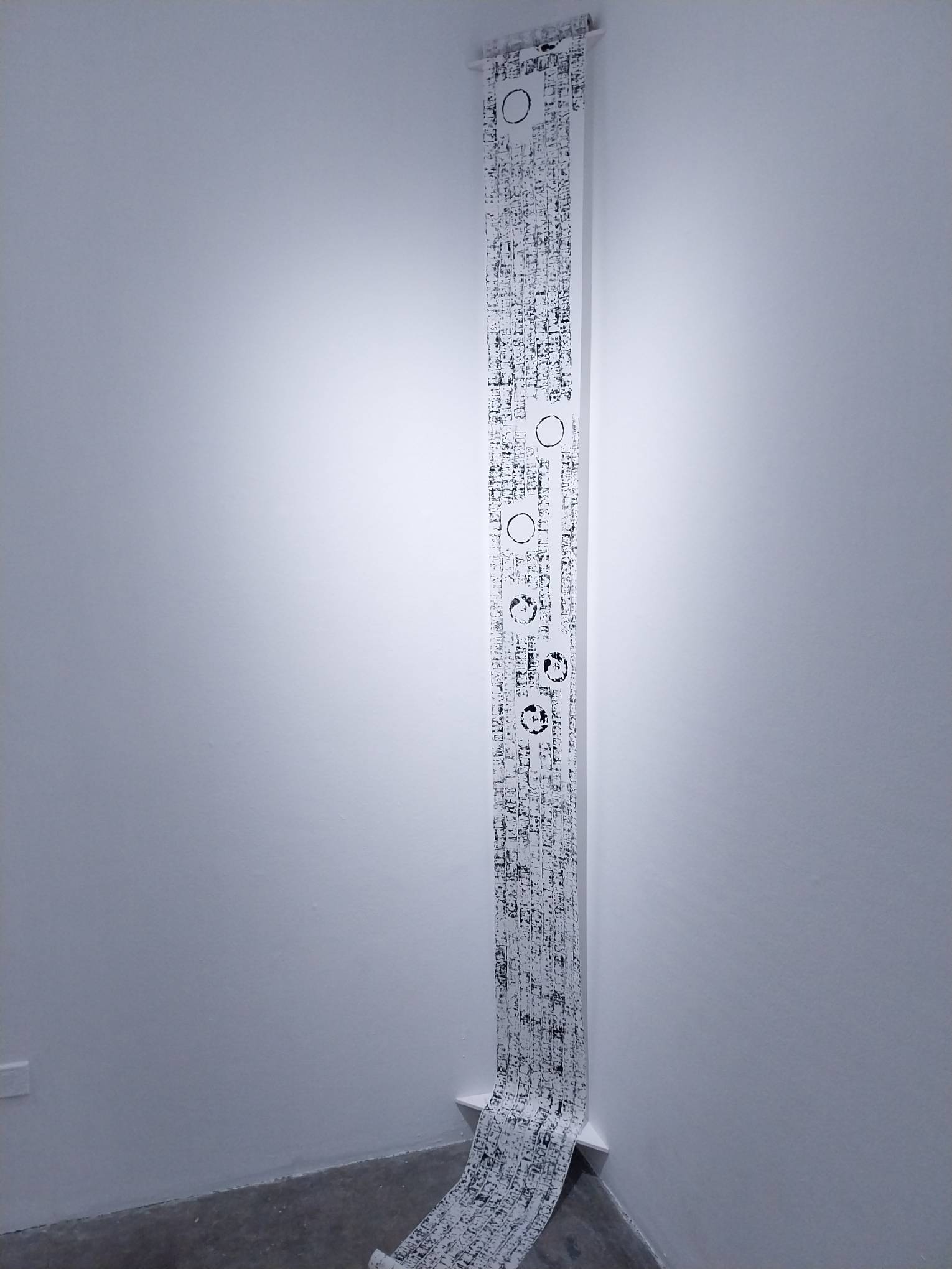 The scroll by Julieanne Ng filled with imprints from a candle.