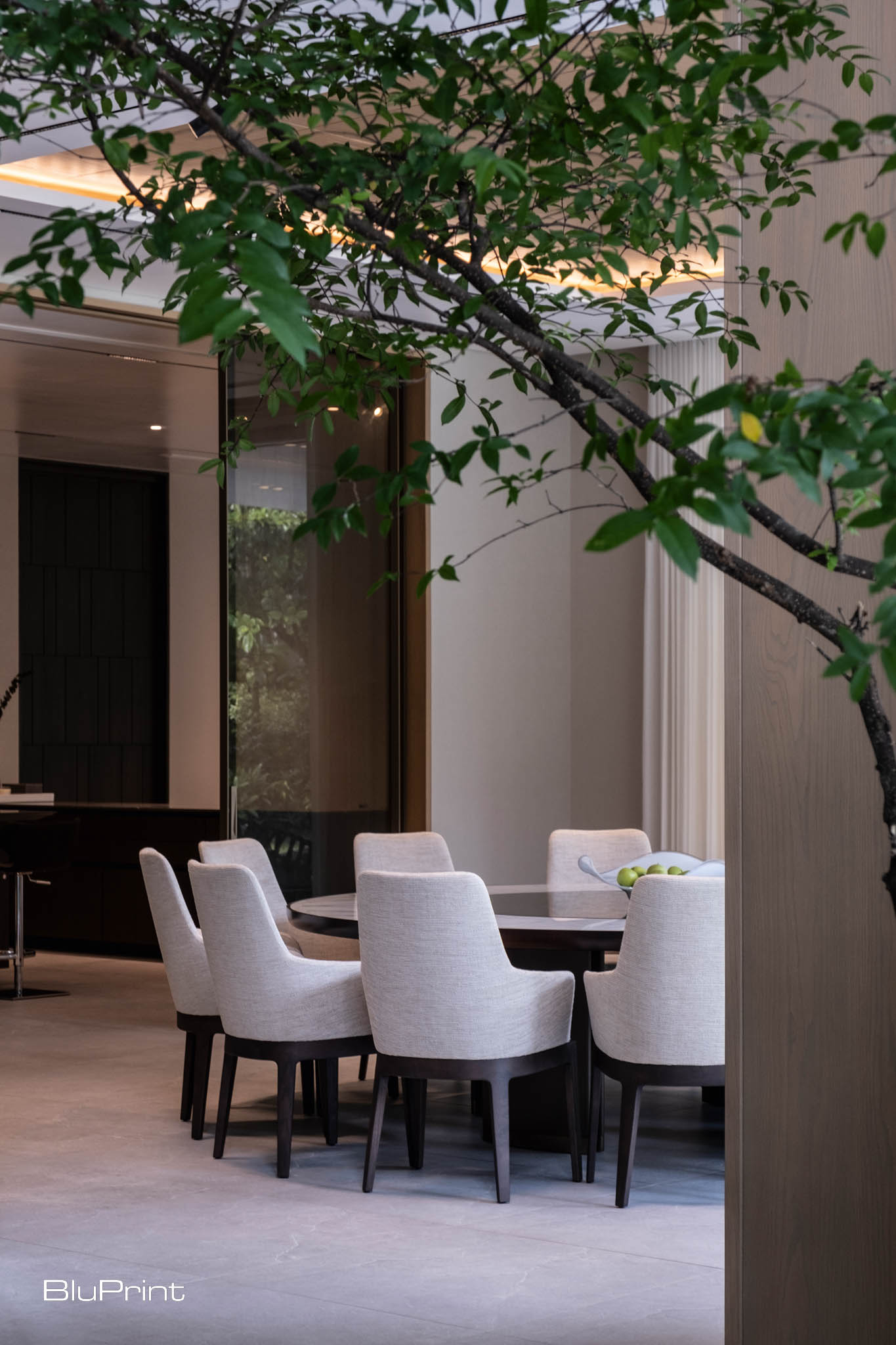 Beauty in Subtlety by Nazareno Architecture + Design. A round, 12-seater dining table sits in the main dining area—perfect for entertaining a large group.