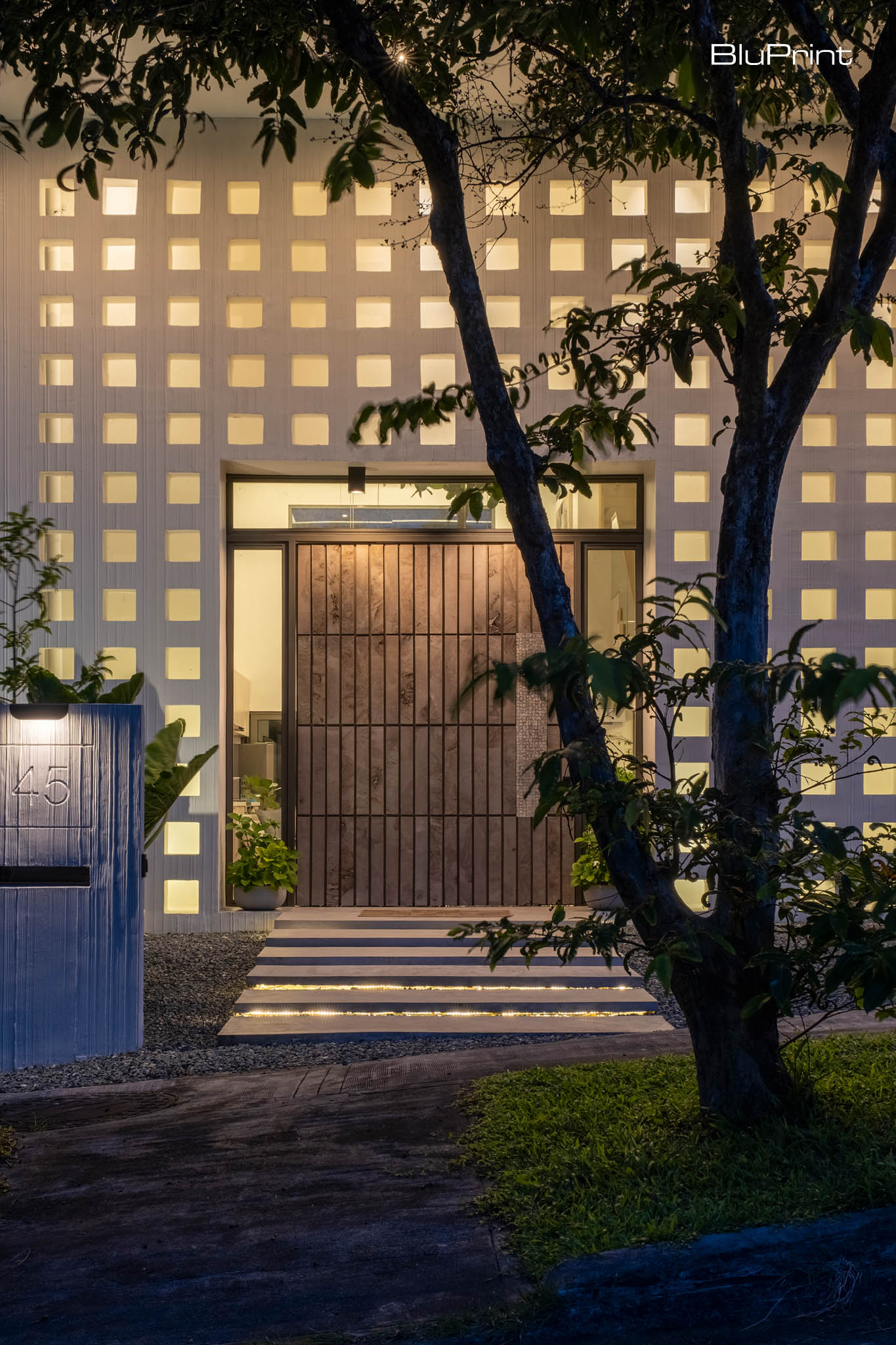 The grains on the front door add a warm, organic touch to the facade of the house. Tampipi House: Designing Outside the Box by Carlo Calma.