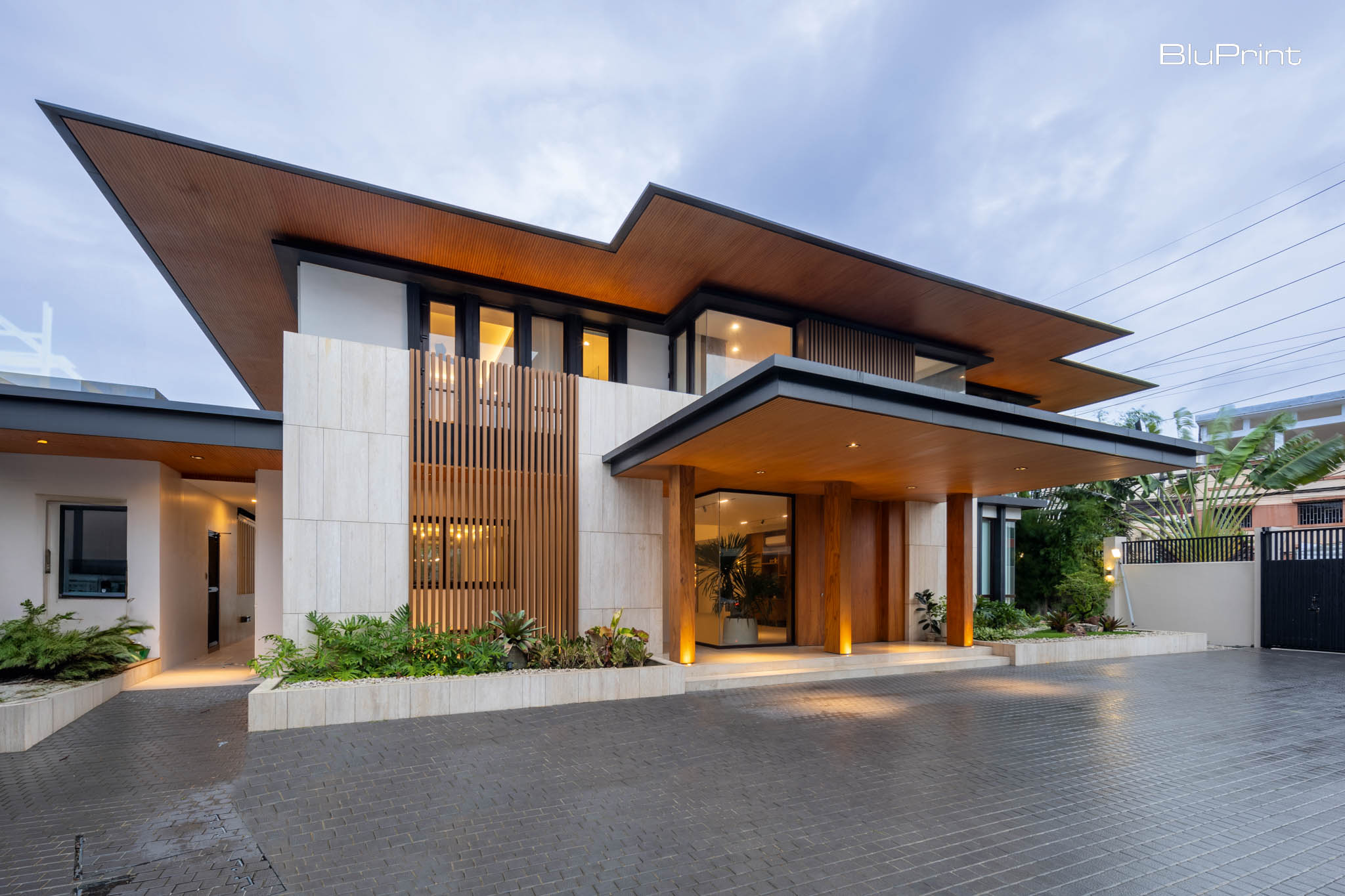 CC House: Modern Filipino Family Haven. The exterior of the house features Wood Plastic Composite (WPC) and marble cladding, achieving a contemporary Filipino aesthetic.
