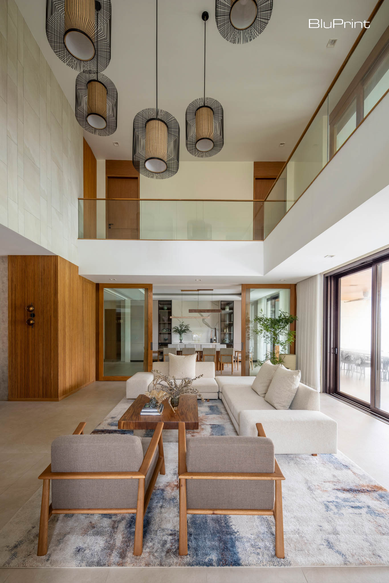 CC House: Modern Filipino Family Haven. A high ceiling gives the living space an expansive, airy feel. From this area, one can see the hallway that leads to the rooms upstairs.
