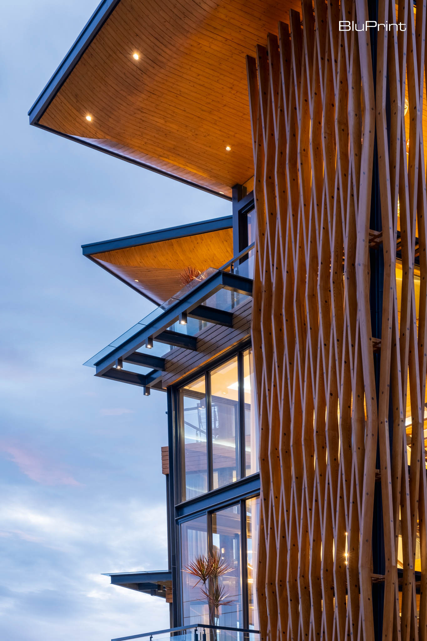 A Serene Mountain Retreat by Fitnesscape Creative Studio Inc. The spacious outdoor deck provides a tranquil space to unwind, with seamless transitions between indoor living areas and the surrounding natural beauty.