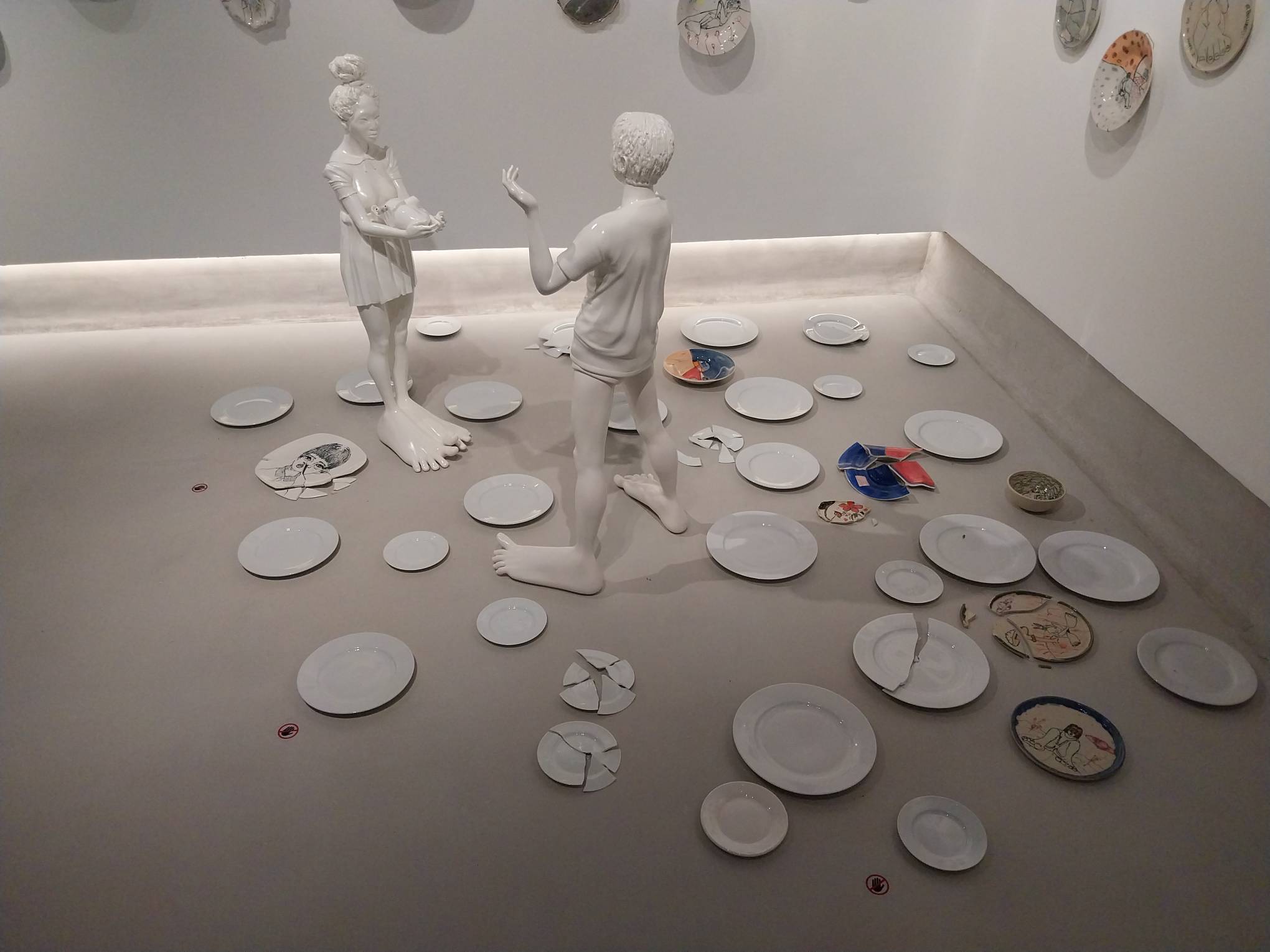 One angle of the work of Ciane Xavier in the exhibit. One of the figures is giving their heart to the other.
