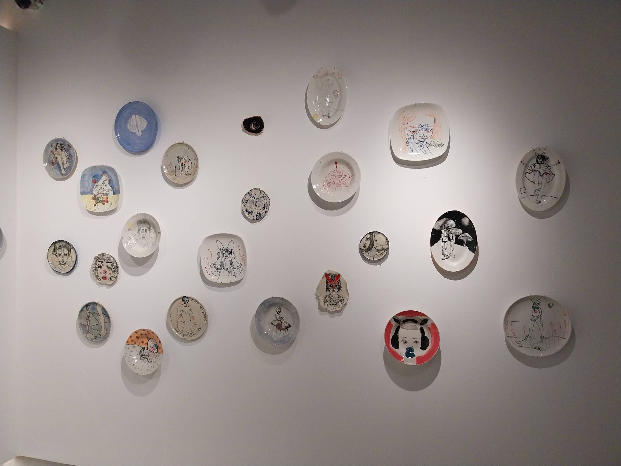 Another wall of porcelain plate artworks by Ciane Xavier.