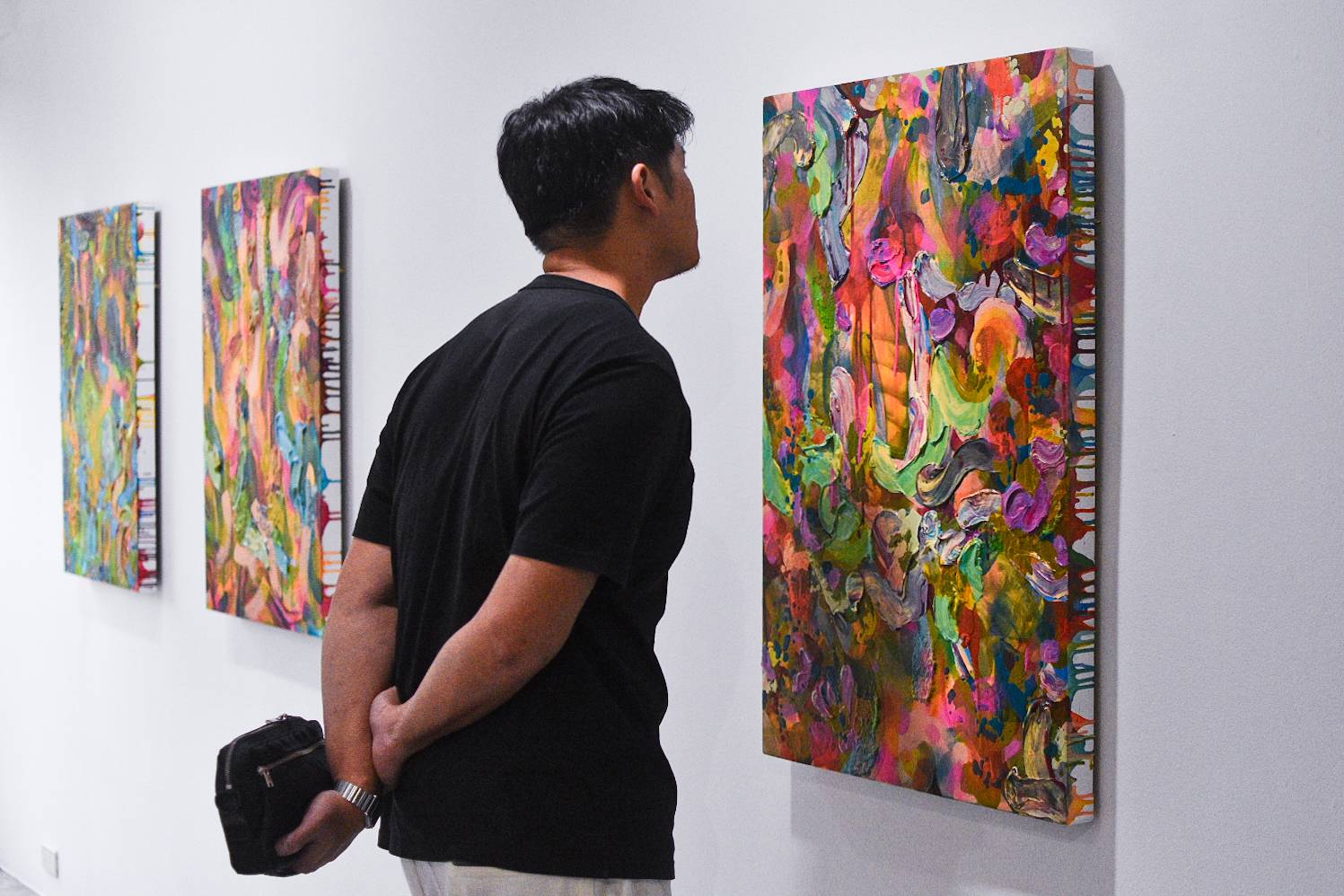 Curator Soler Santos analyzing a painting by Patrick de Veyra for "Storm in a Teacup."