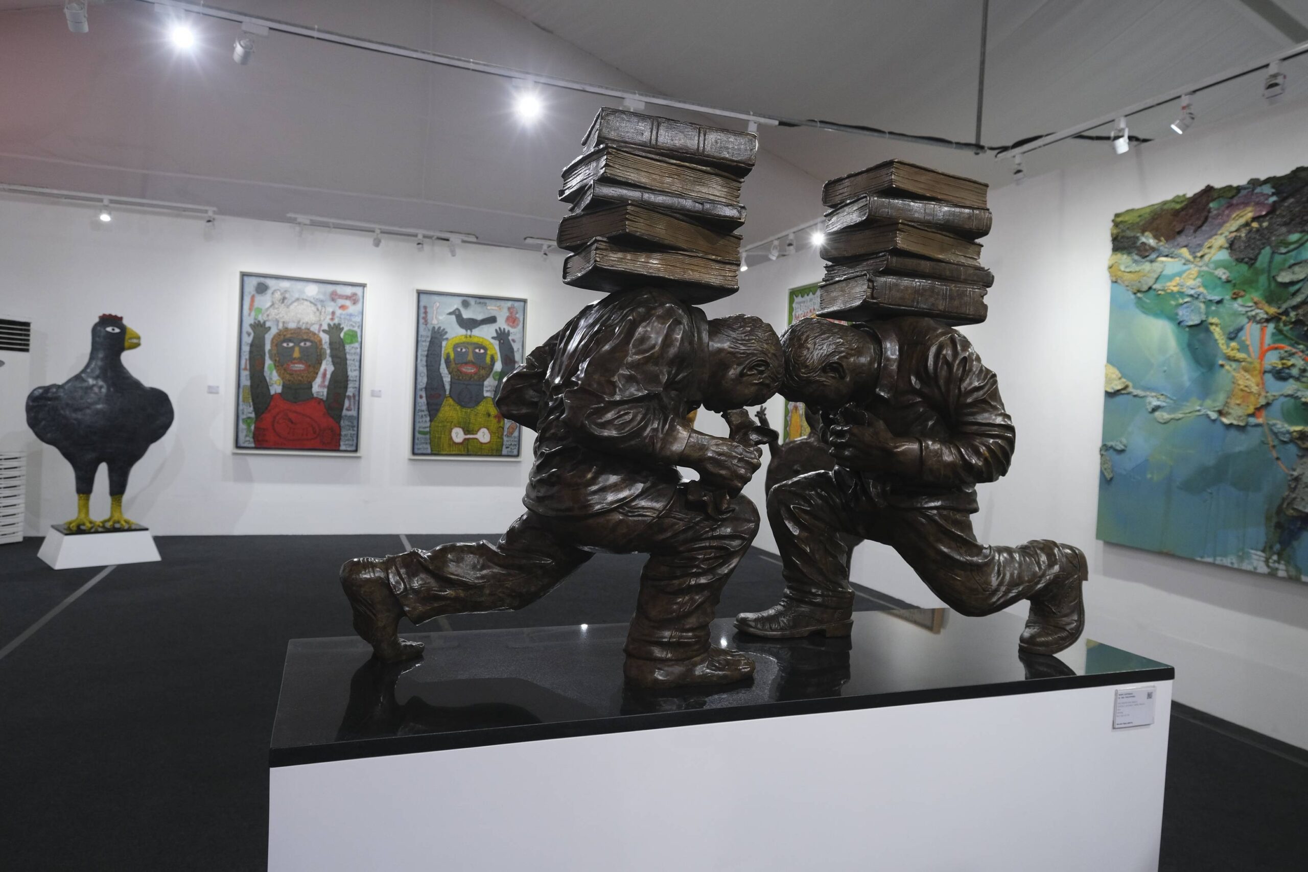 Sculpture of two people crouching at Gajah Gallery.