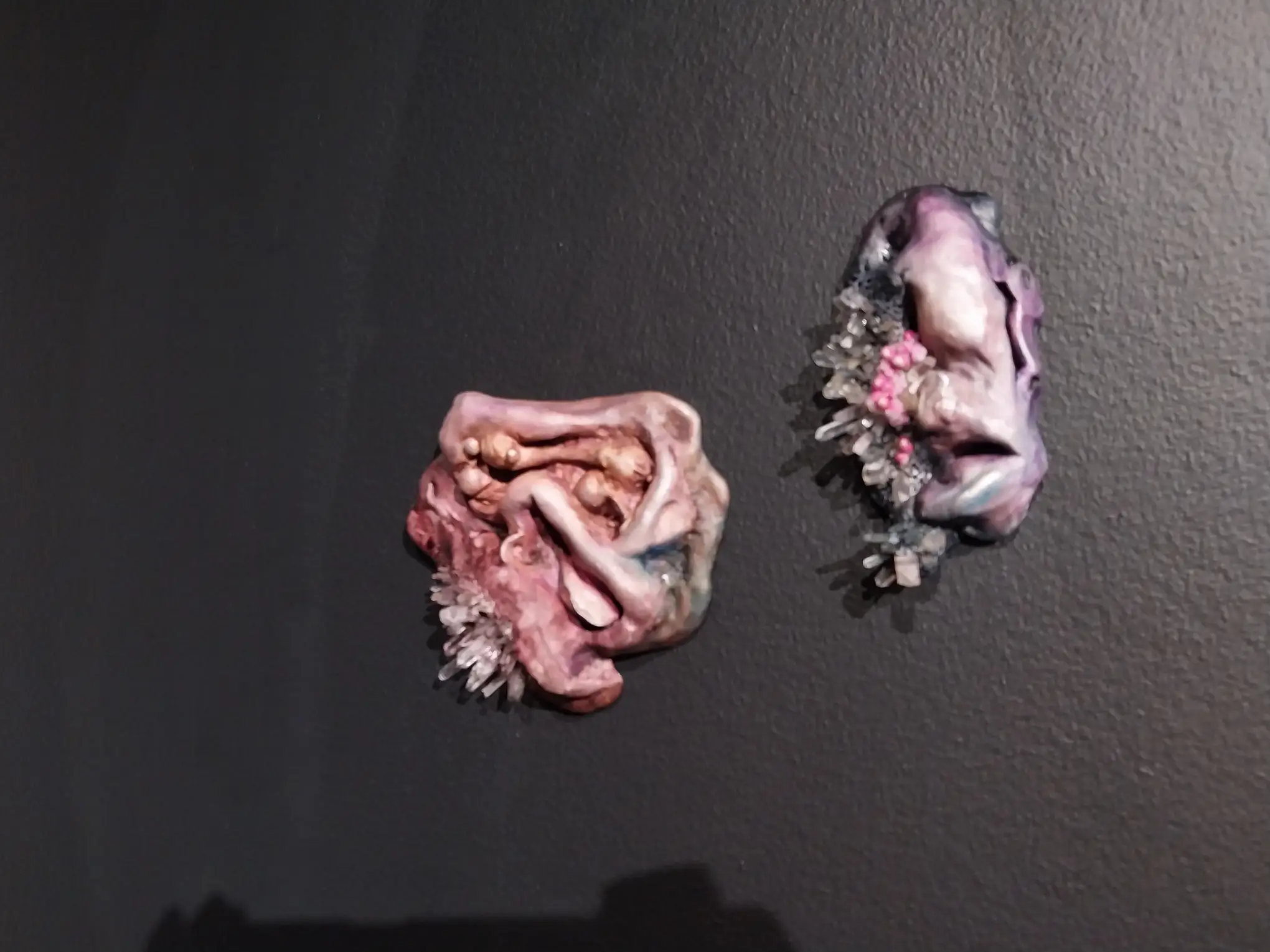 Two works by Sam Feleo for "Grip/Pulse" with crystals embedded in the structure.