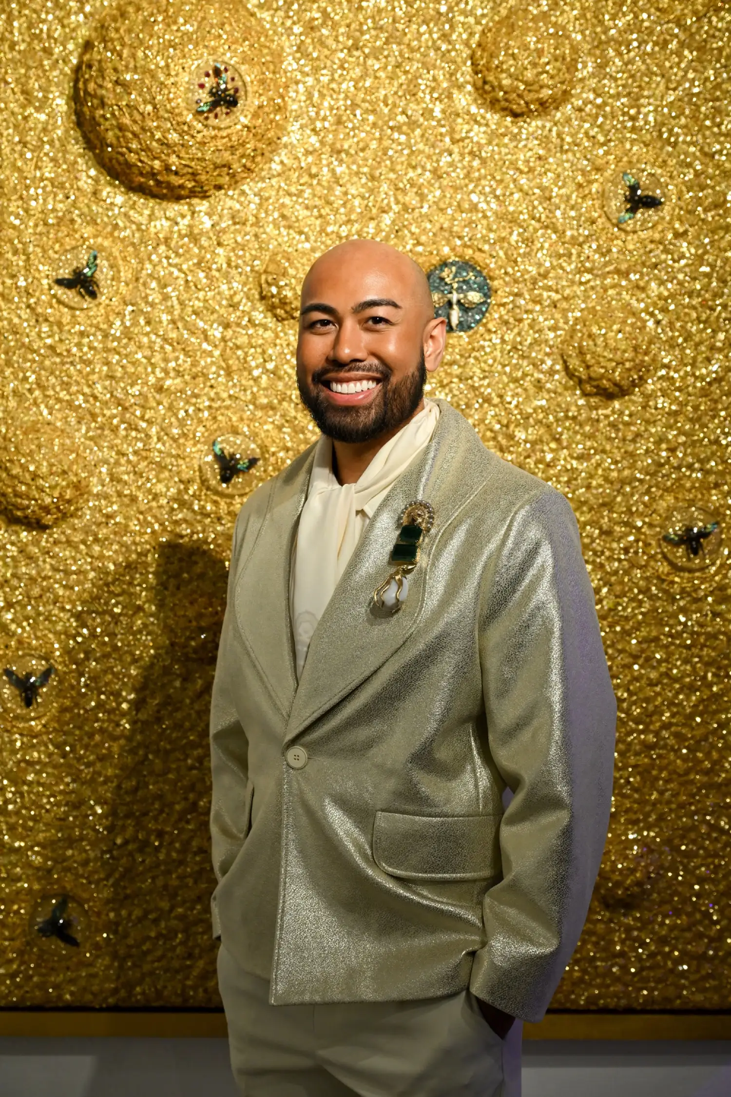 Abraham Reyes in front of one of his artworks for "Beneath the Surface."