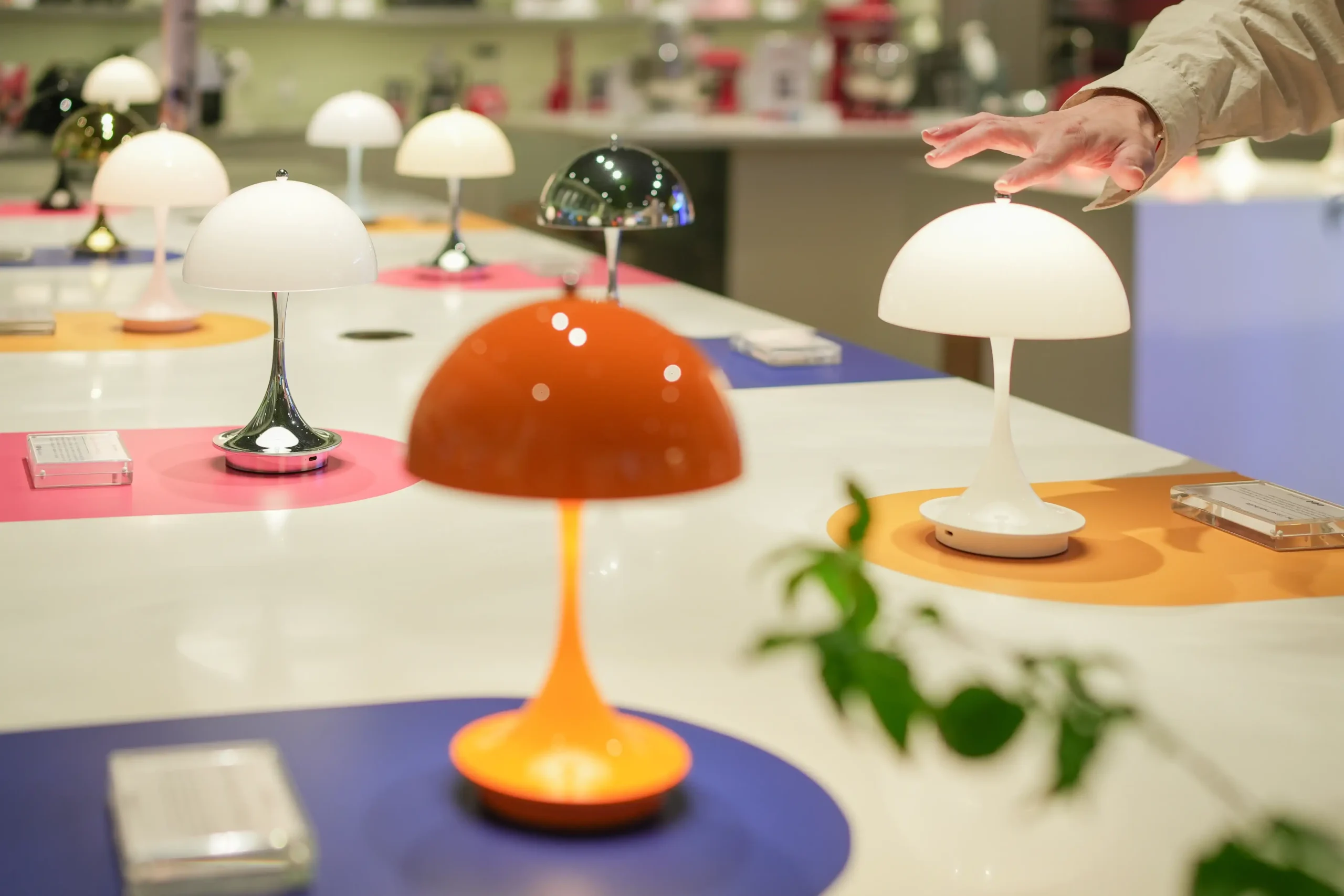 Panthella Portable 160 displayed on a long table.