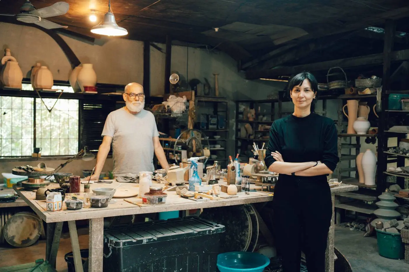 Jon and Hanna Pettyjohn posing in the ceramics workshop in Laguna.