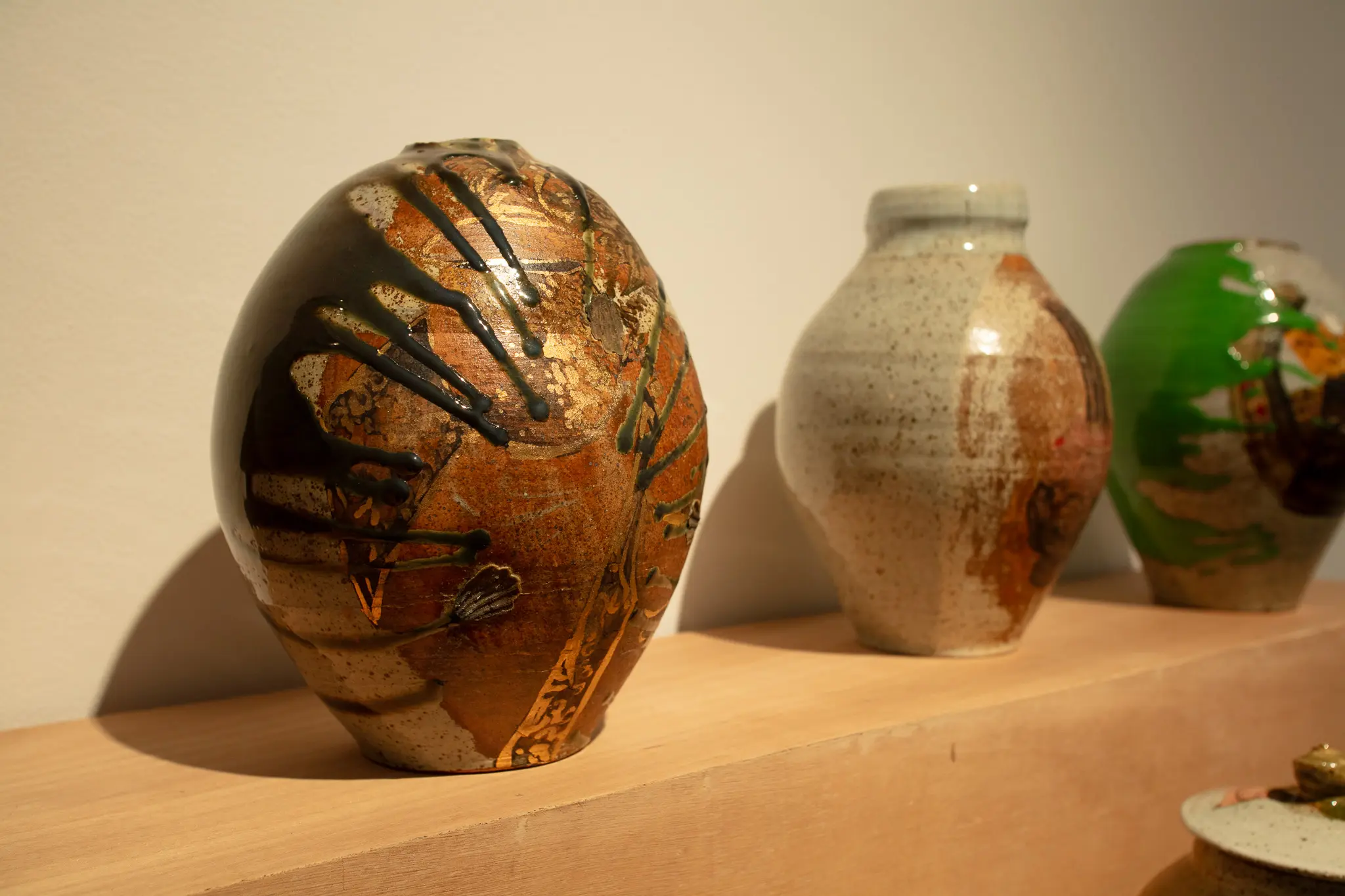 Close-up look of some of the ceramic art by Jon and Hanna Pettyjohn, with the glaze running through the work.