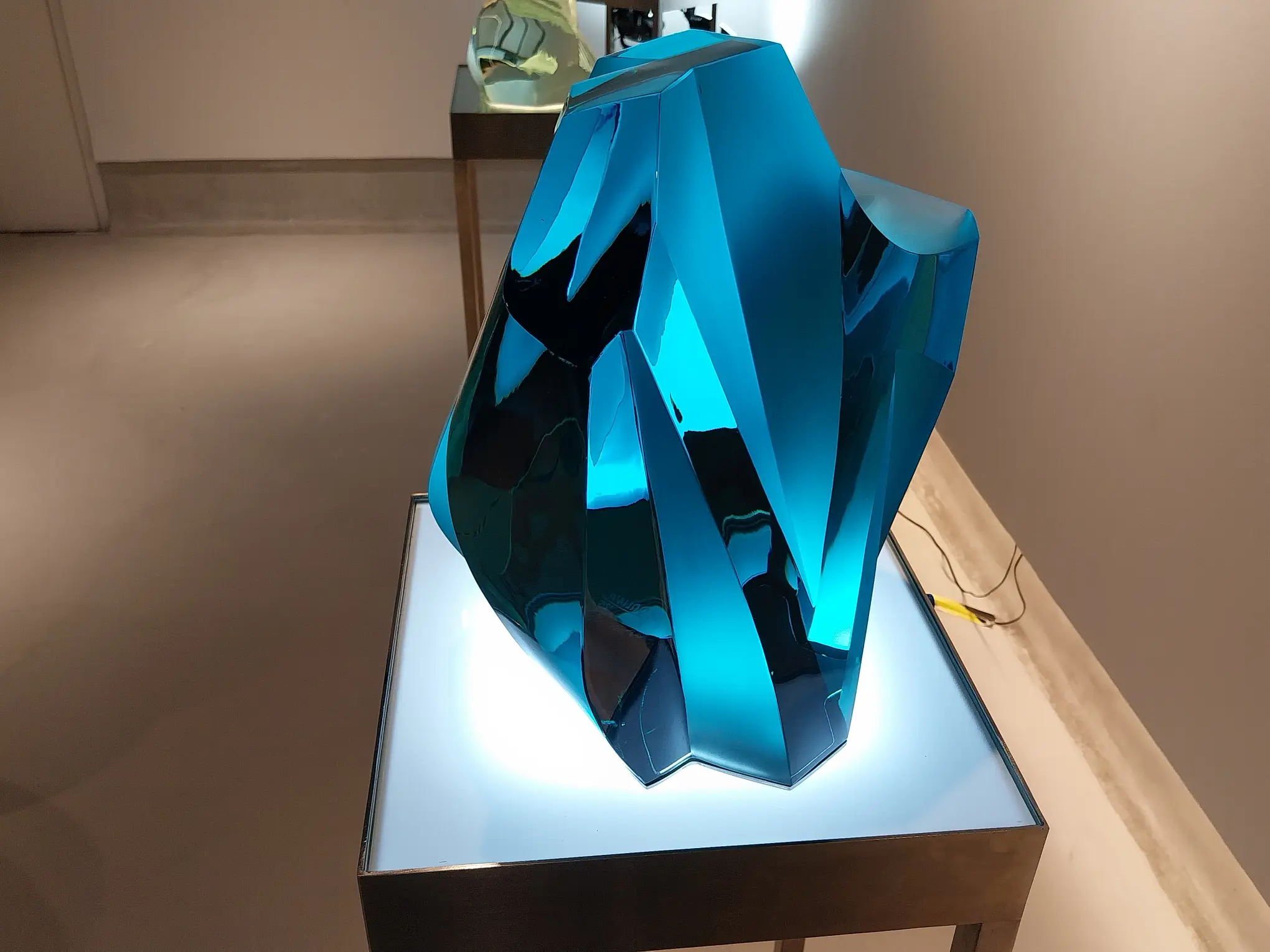 A blue glass art work by Michael Orlina.