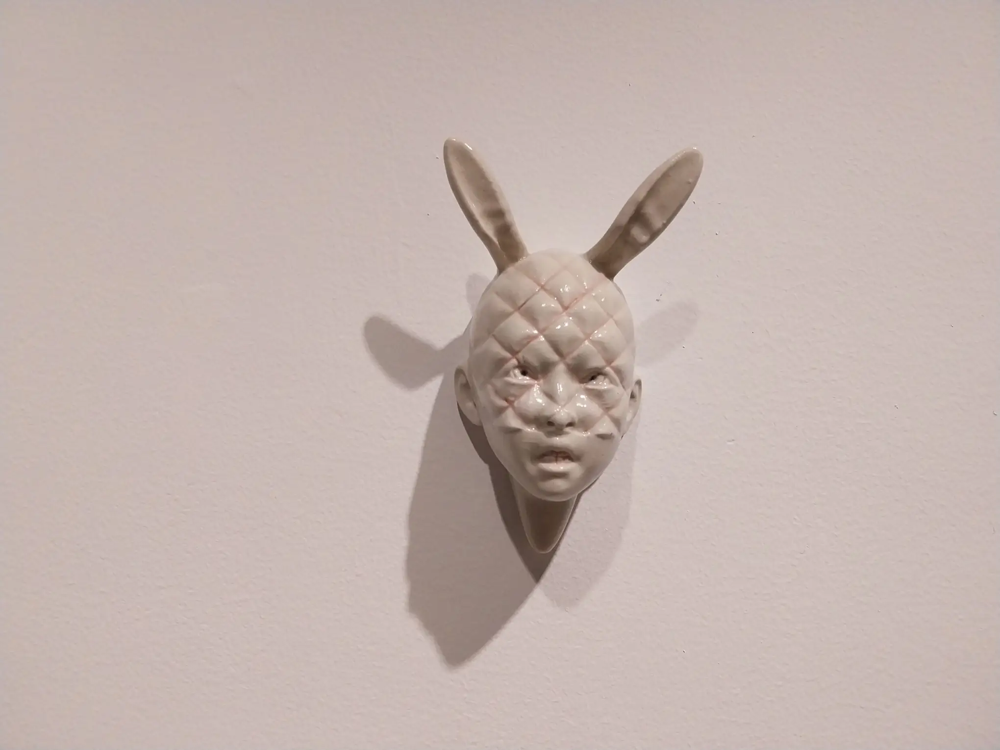 A human-bunny ceramics work for "softly, firmly."