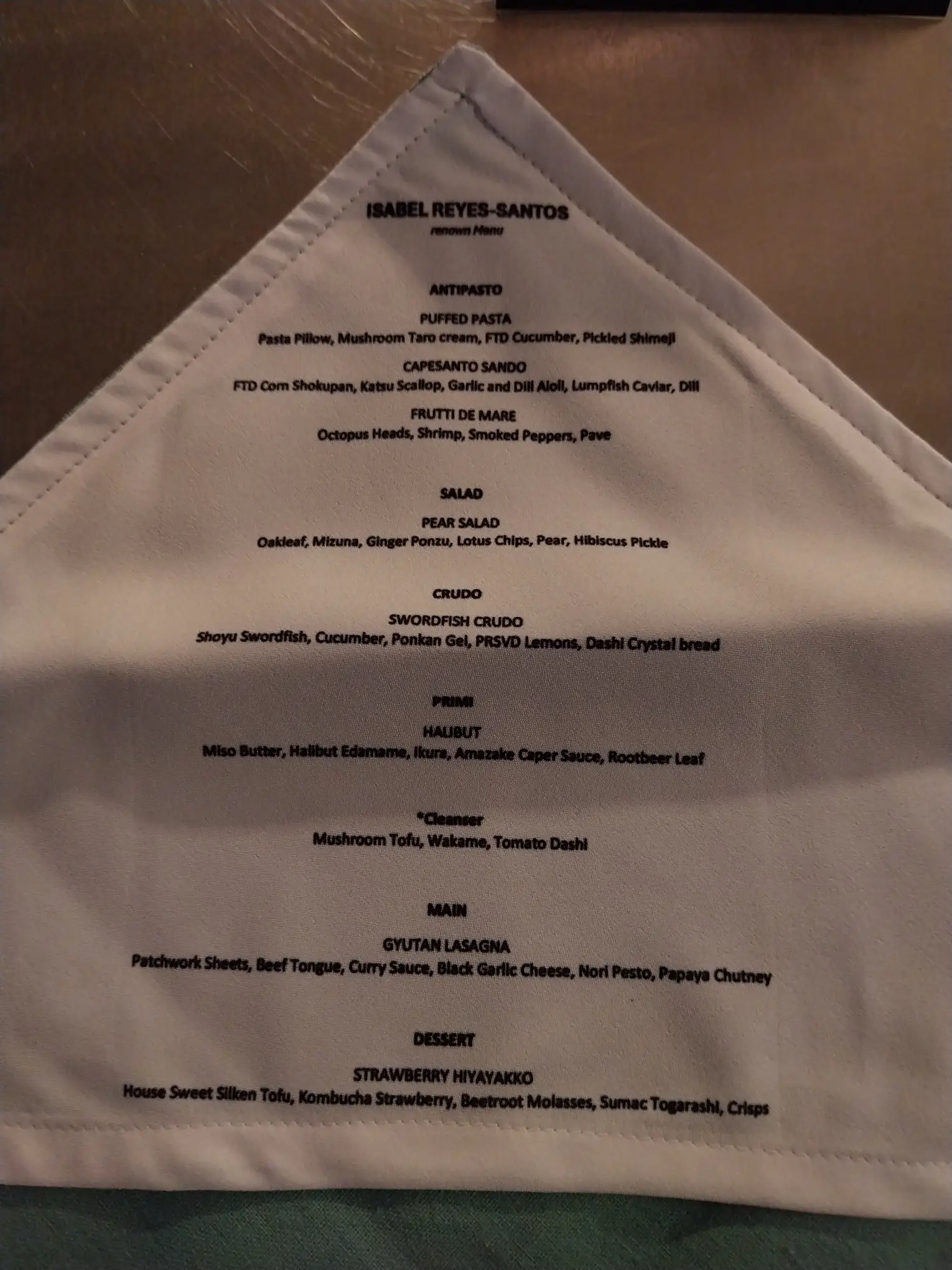 The menu for 'reNOWn x Isabel Reyes Santos,' printed on a napkin.