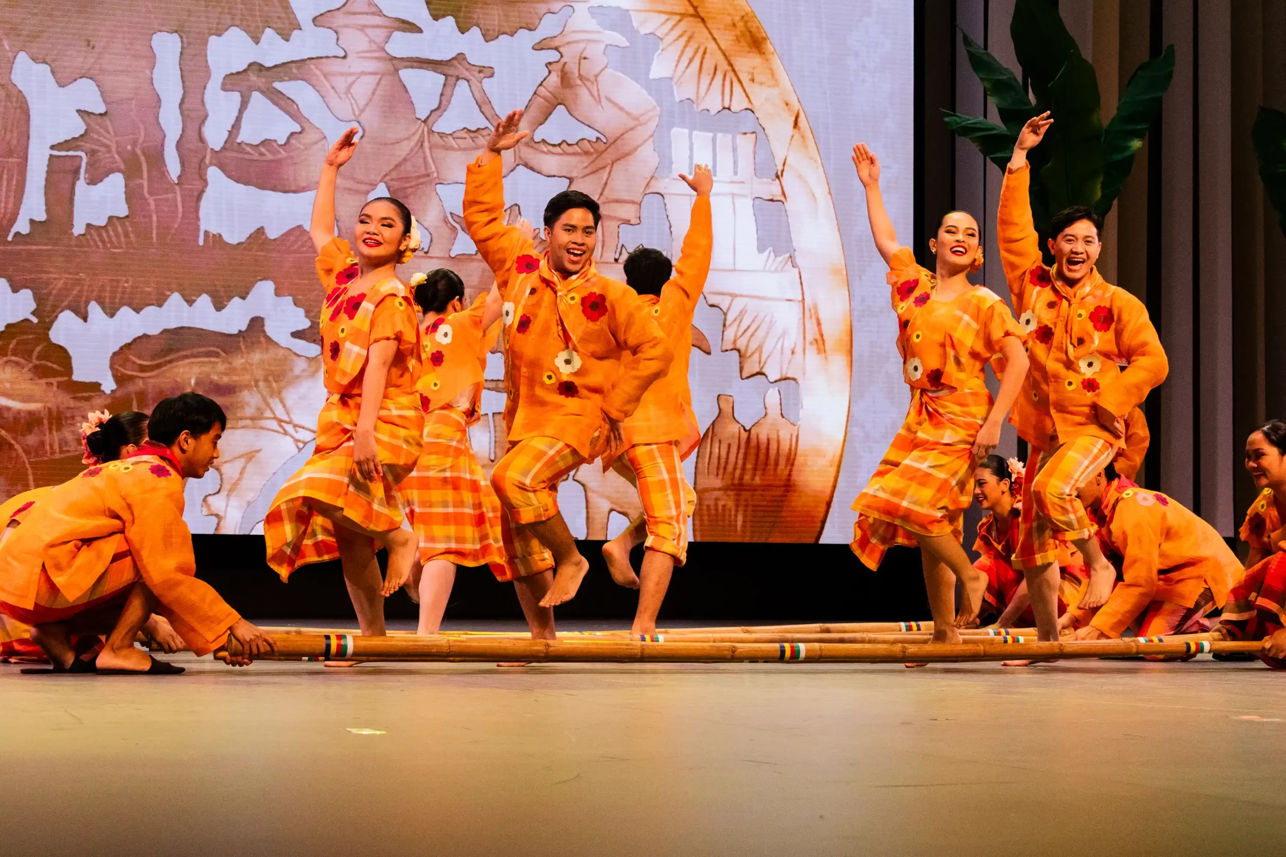 The Visayan dance of Tinikling mimics the long-legged tikling bird avoiding traps set by farmers in the fields. Piña-seda from Aklan and hablon from Antique serve as the primary fabrics used in the traditional kimona and camisa. Designer: Abdul Gaffar.