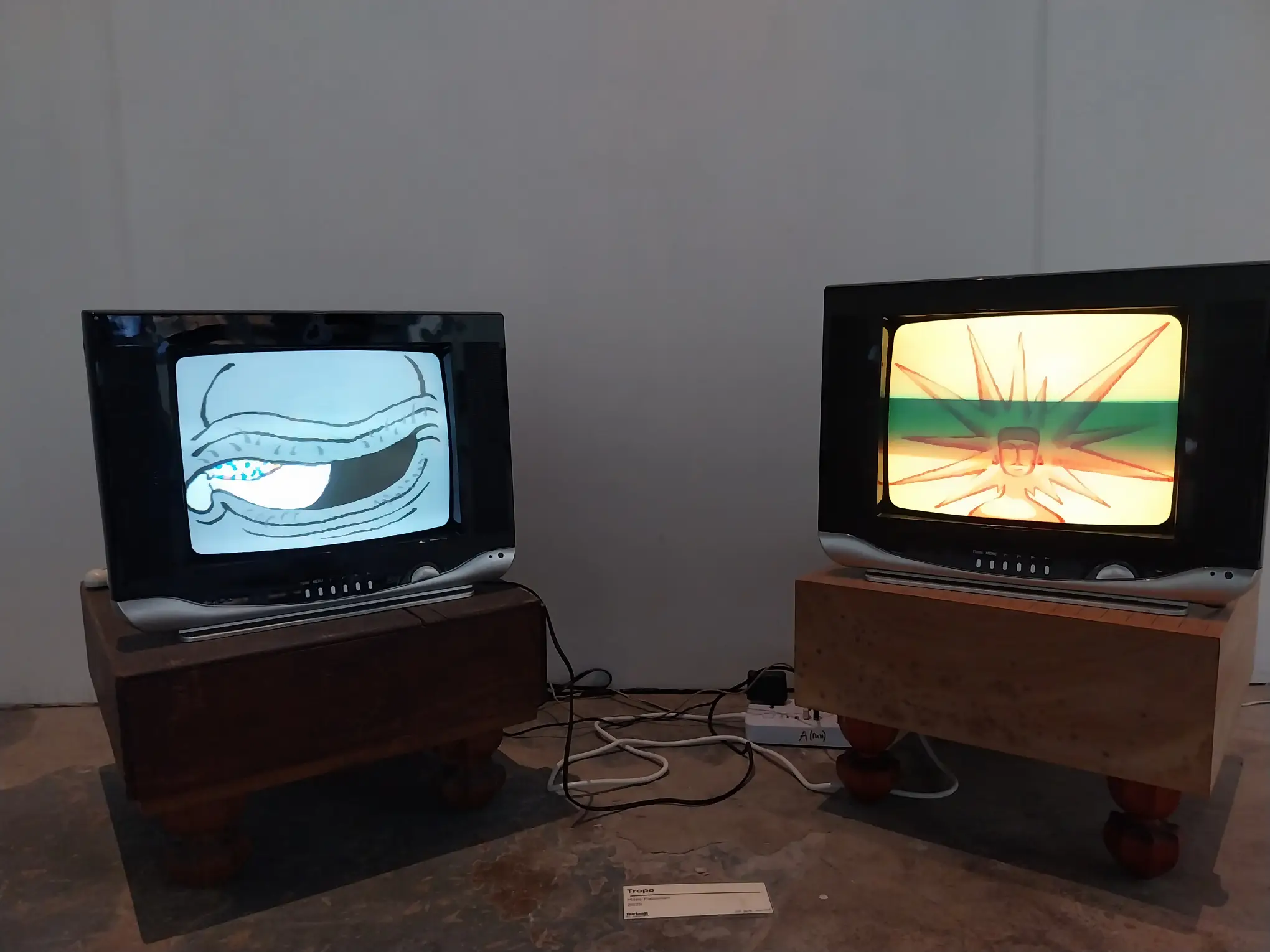 Two television screens showing images at "furball ex machina."