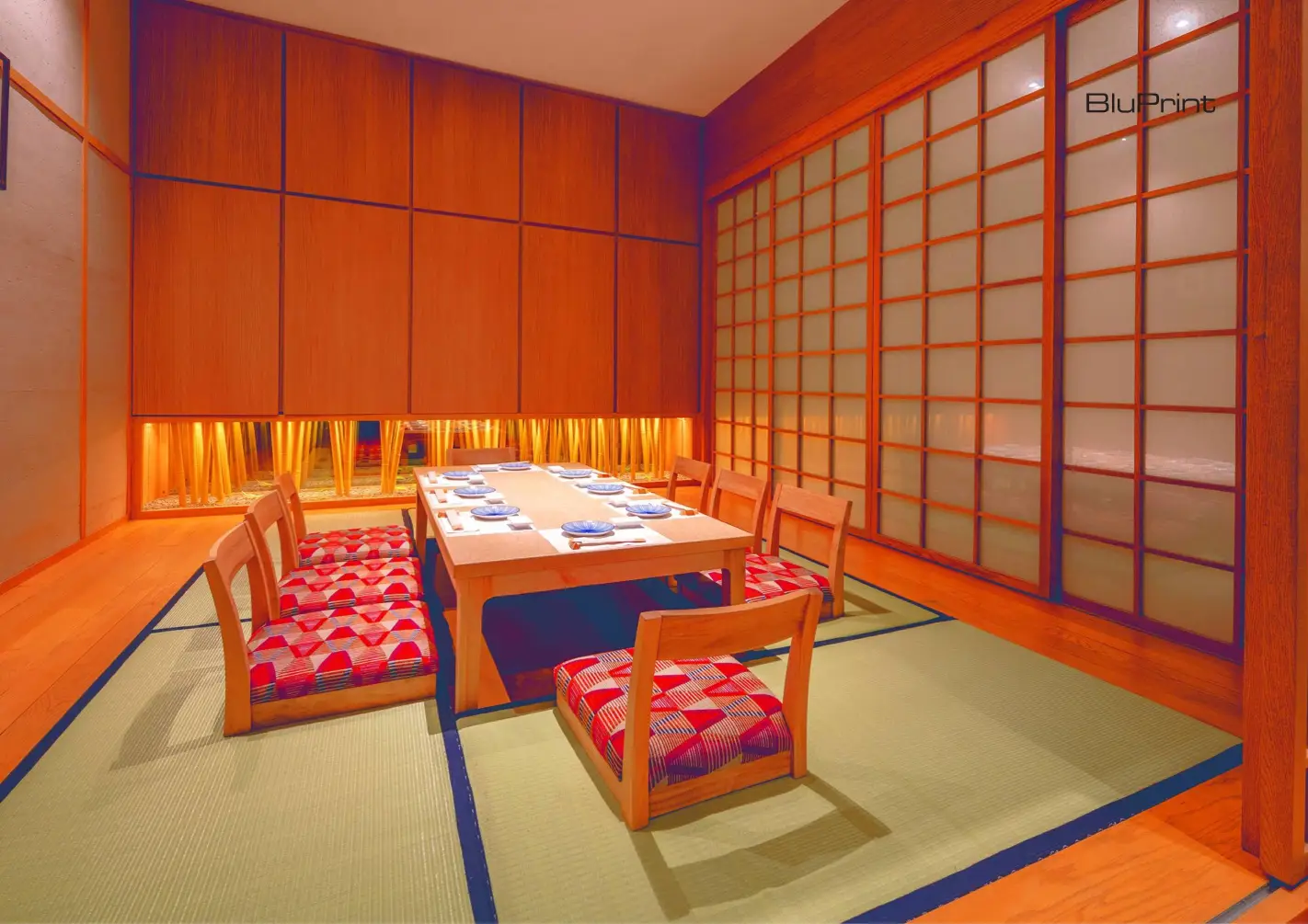 Private tatami rooms feature low wooden chairs with patterned cushions—subtle accents against the room’s neutral tones. 