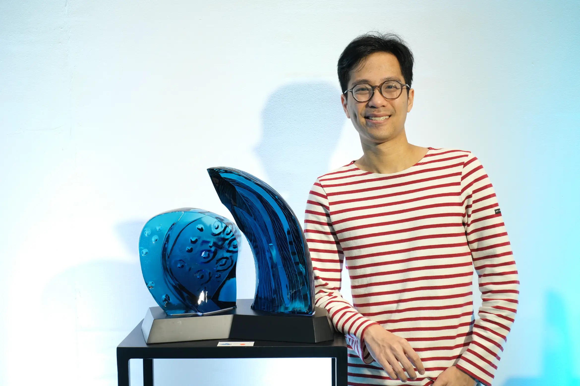 Michael Orlina with two of his sculptures for "RAM: Nature's Abundance."